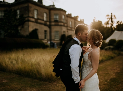 Couple Kiss Outside Stately Home Lincolnshire Wedding