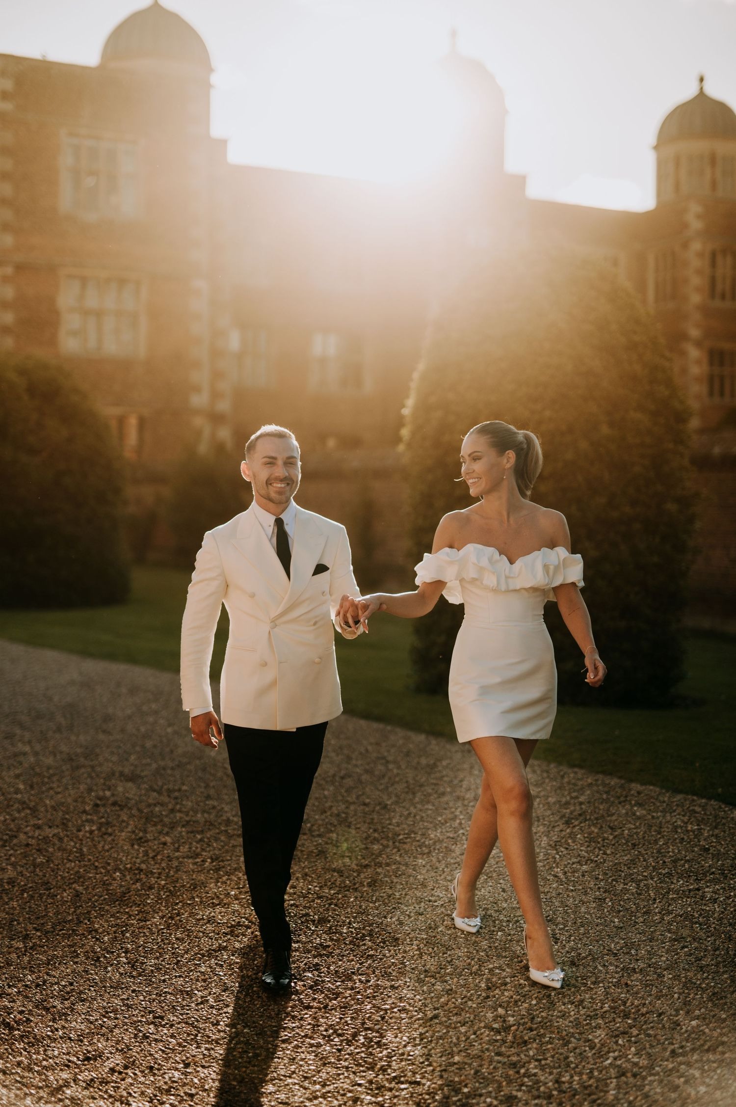 Bride and groom walking at sunset in Lincolnshire countryside