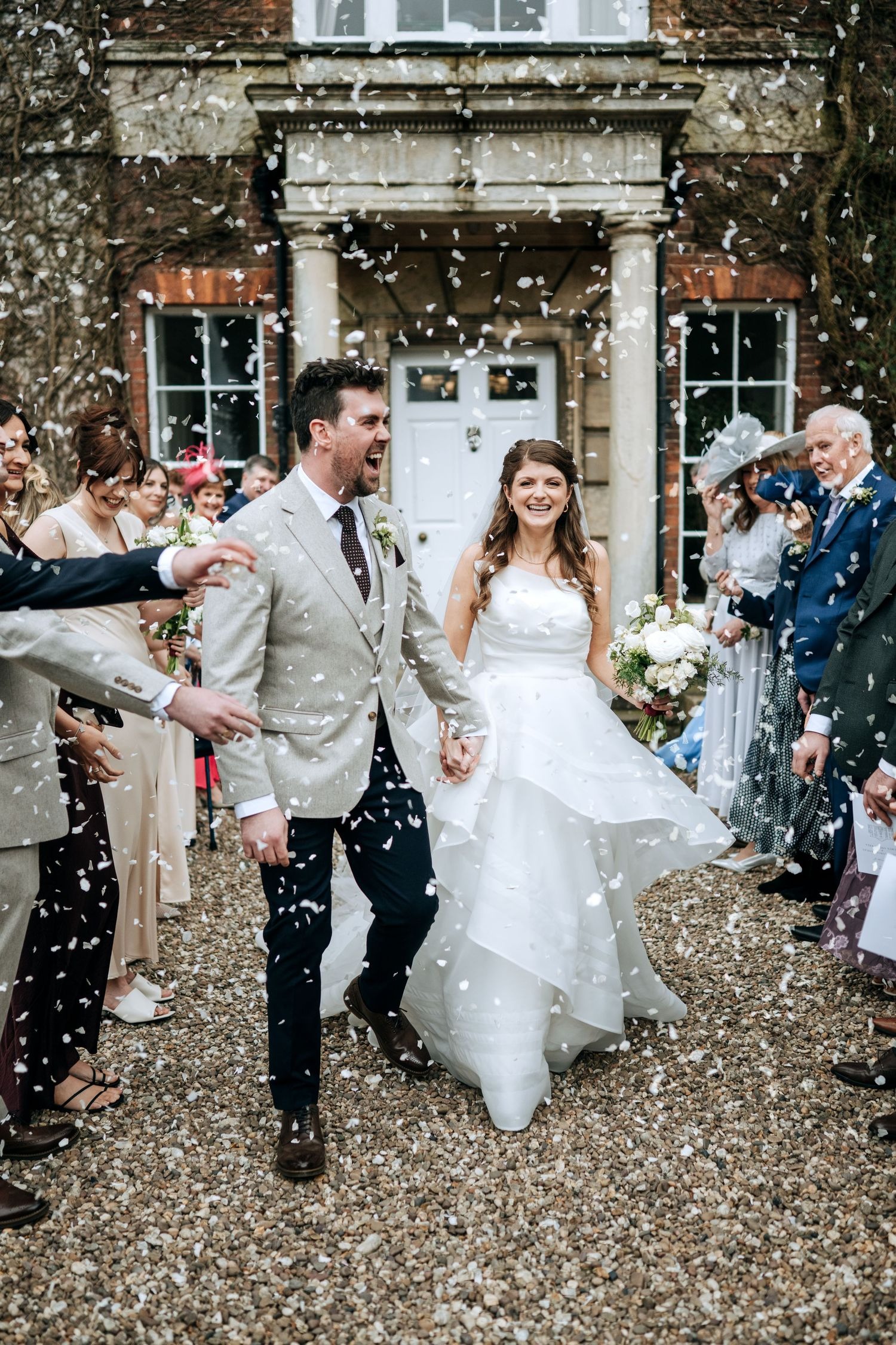 Bride and groom celebrating outside Lincolnshire wedding venue