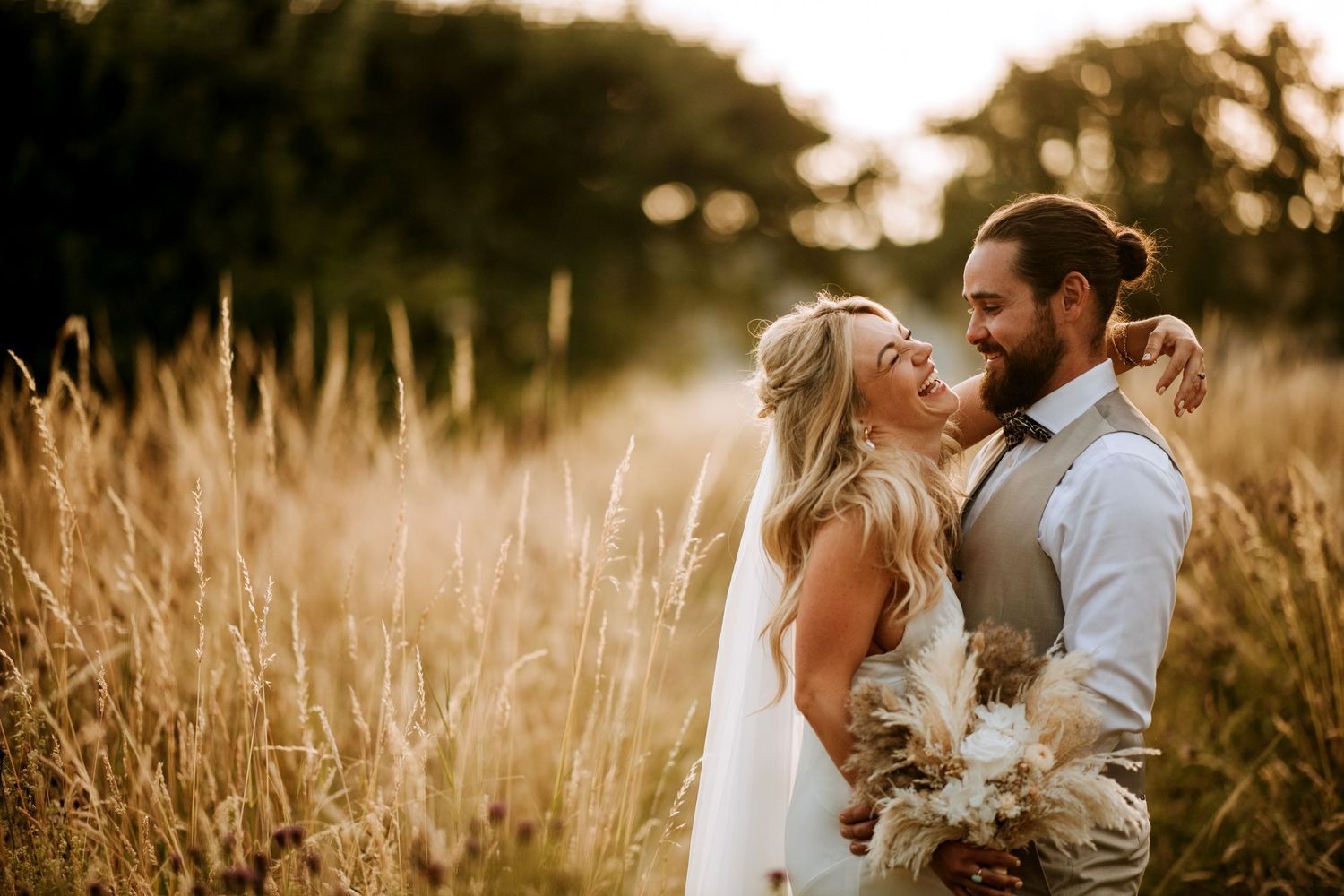 Couple portrait in long grass at sunset in Lincolnshire