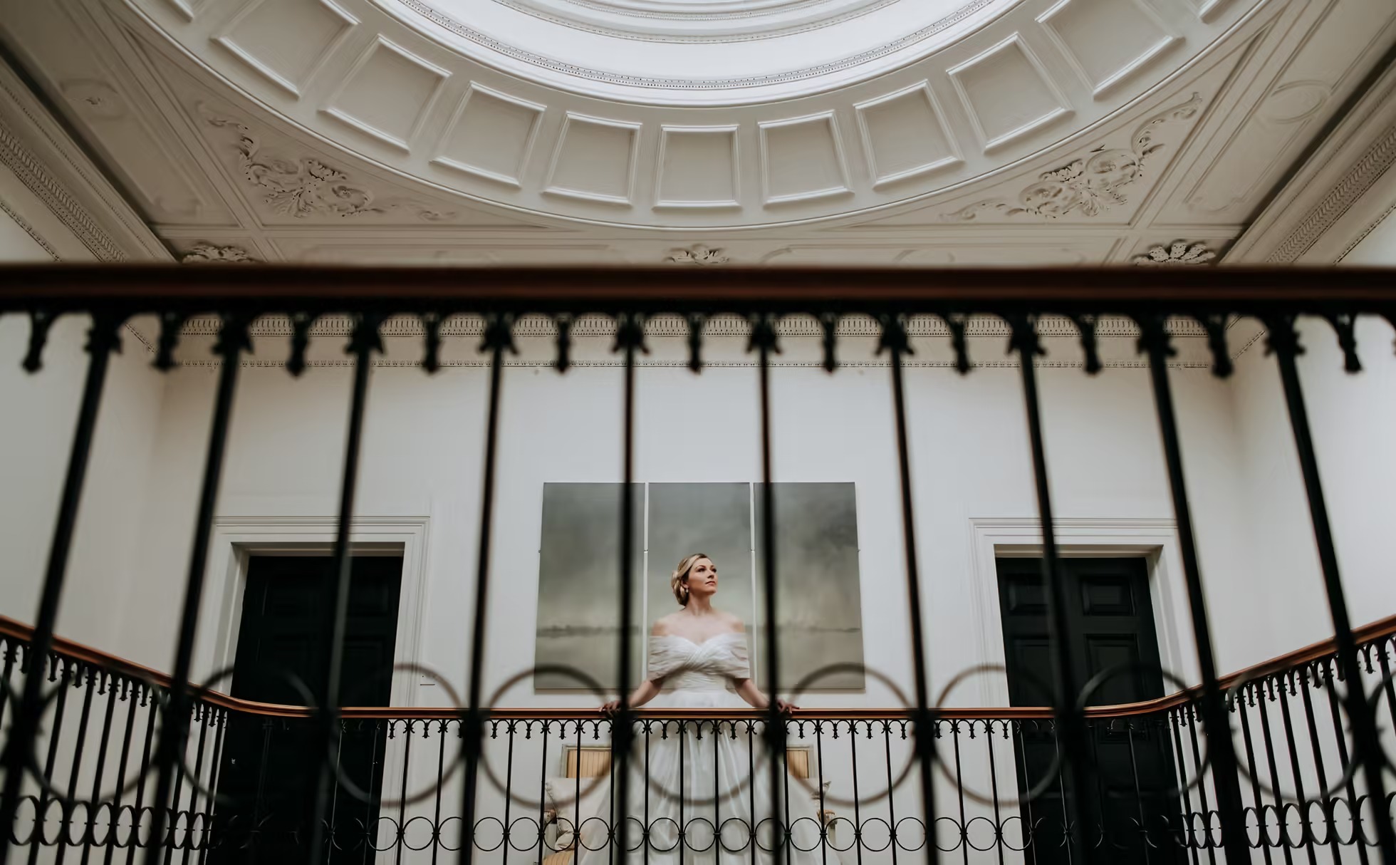 Bride standing on balcony at Rise Hall wedding venue in Yorkshire