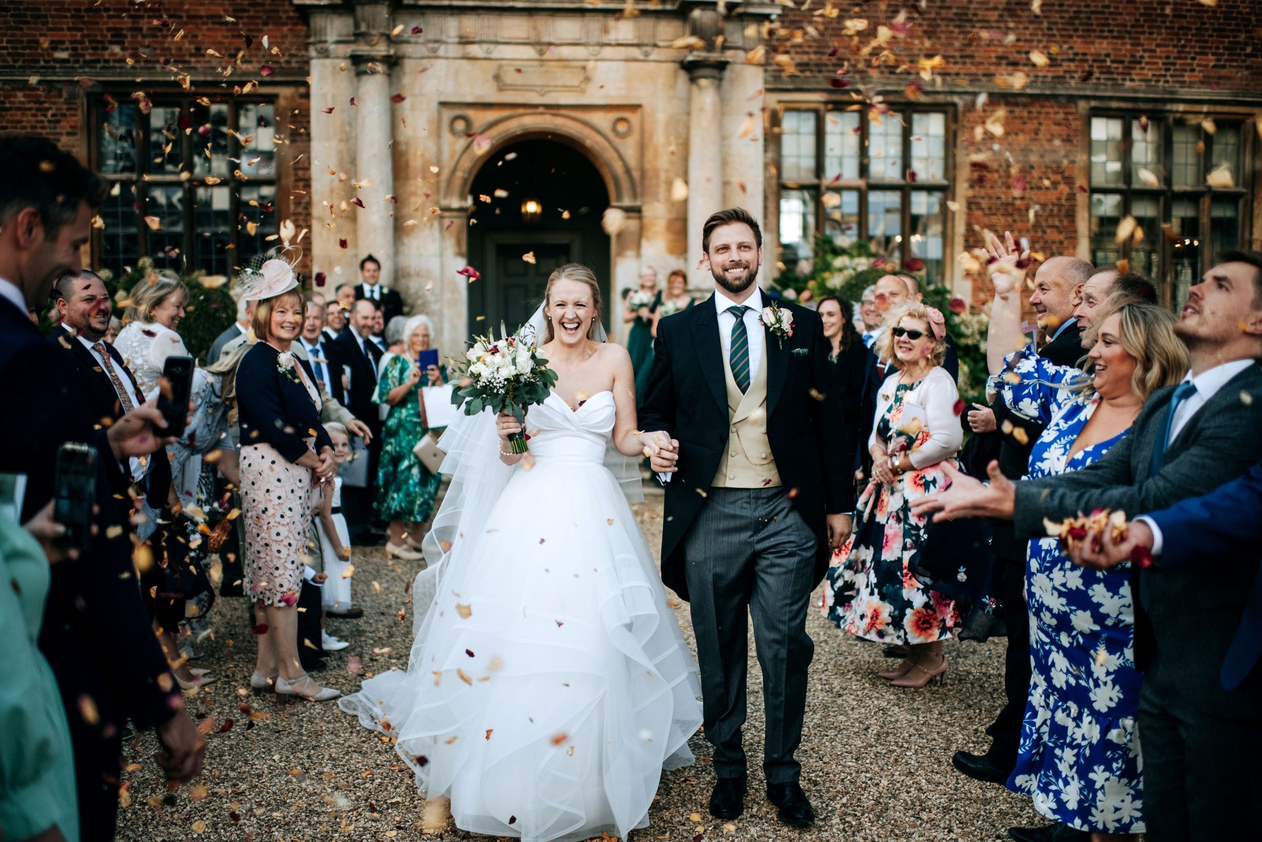 Doddington Hall Wedding Photograph of the Happy Couple with Confetti