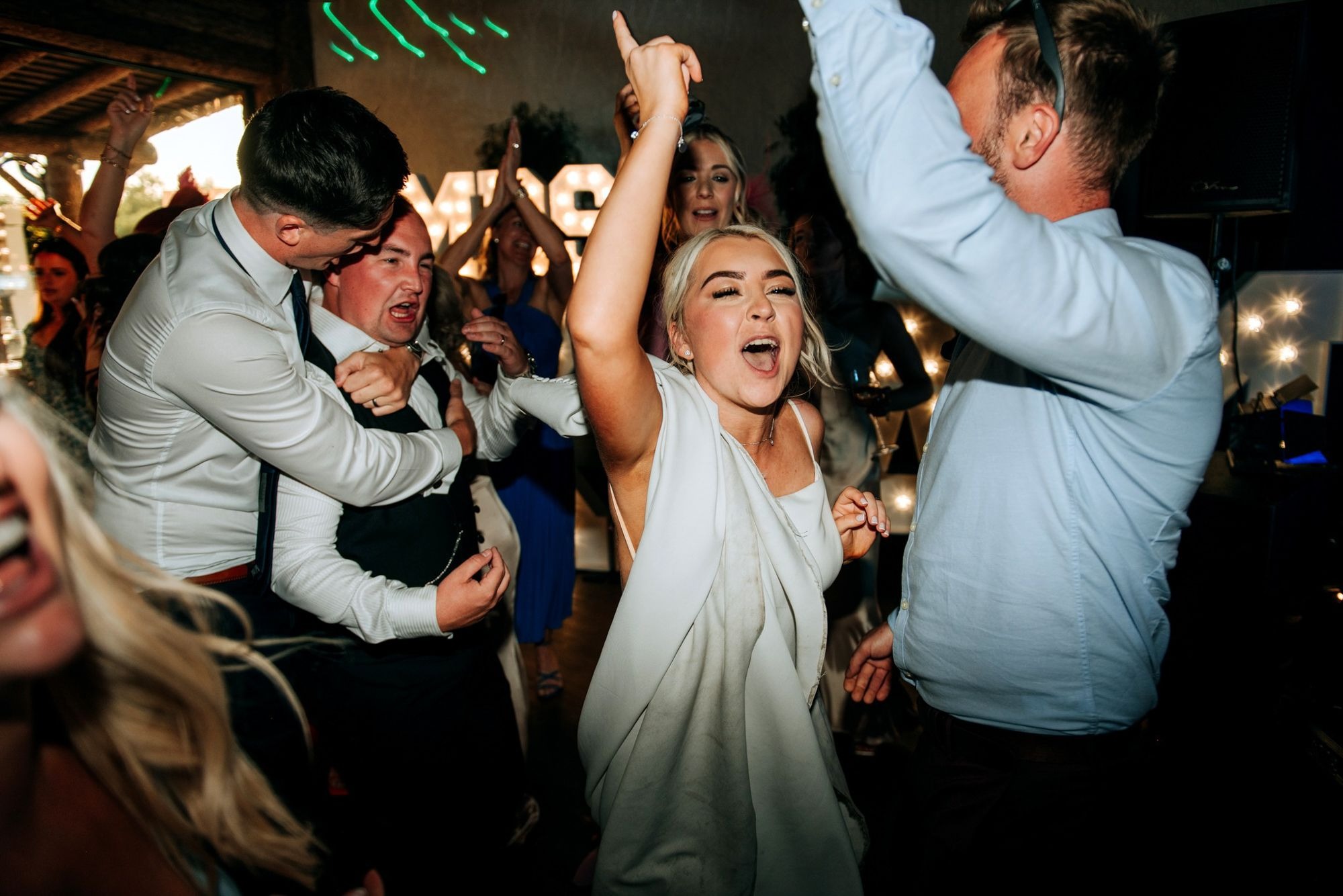 Bride celebrating on the dancefloor at Oaklands wedding reception