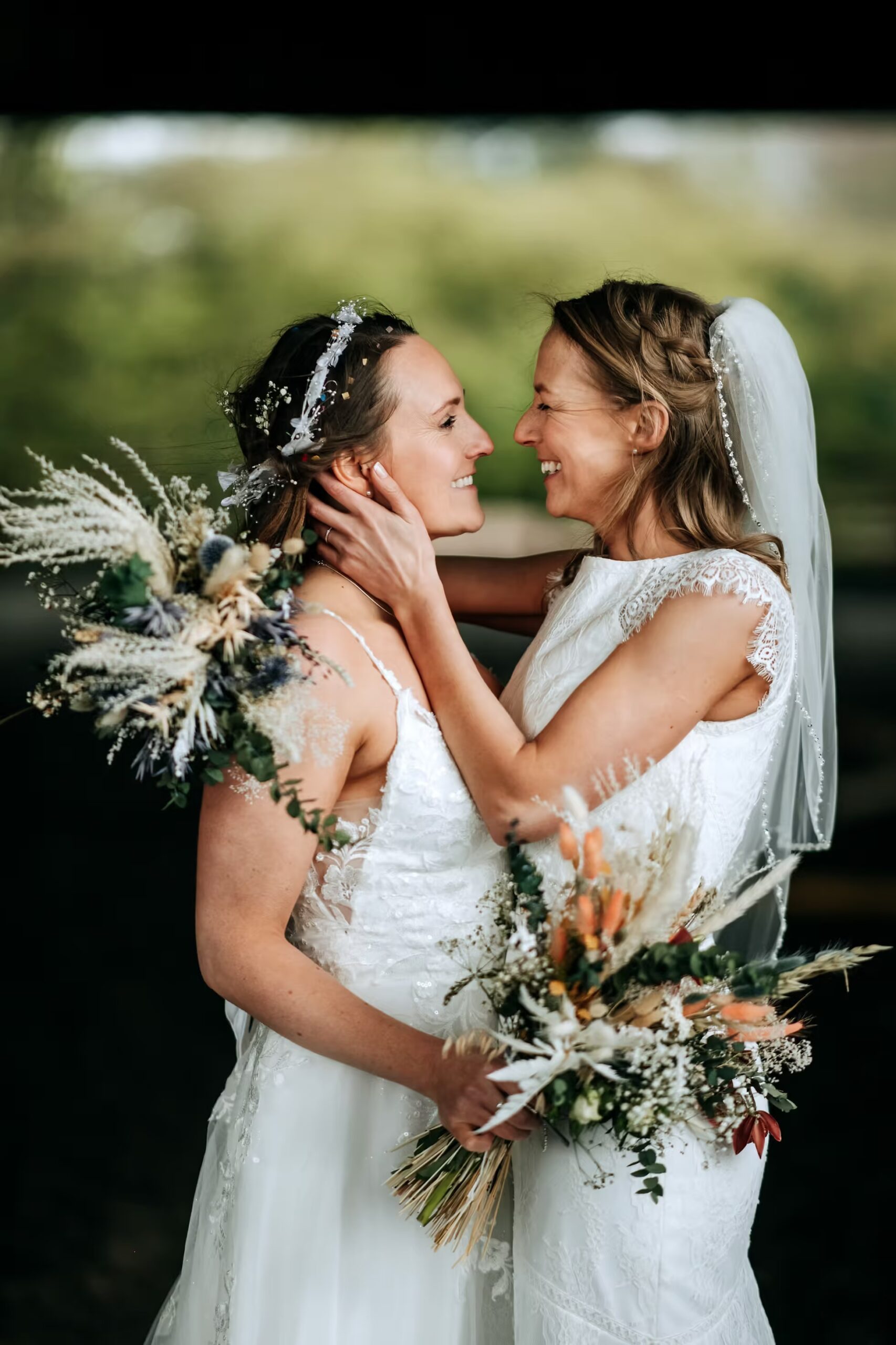 Bride and Bride embracing outdoors at Willerby Barn wedding venue
