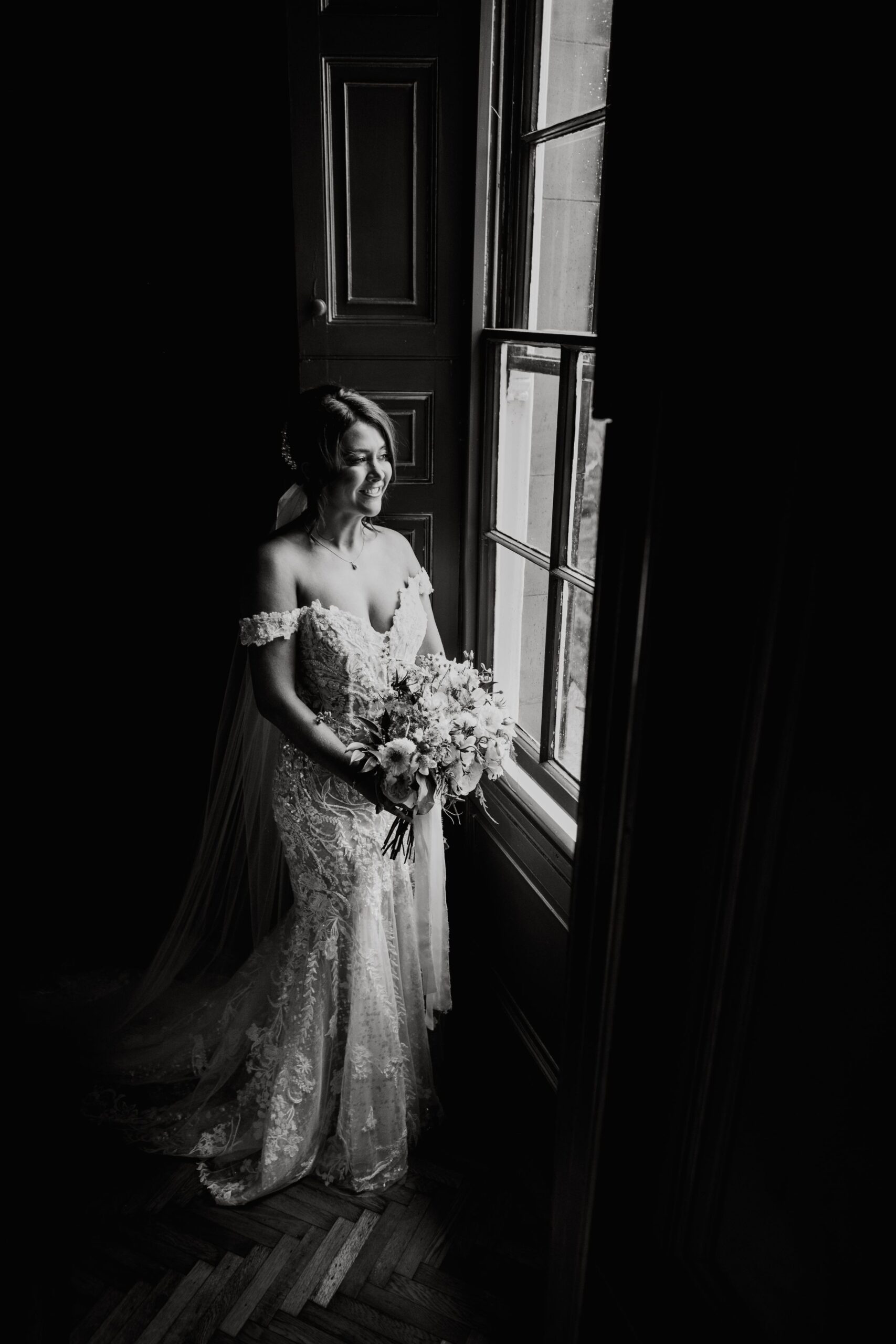Black and white bridal portrait by window at Rise Hall wedding venue