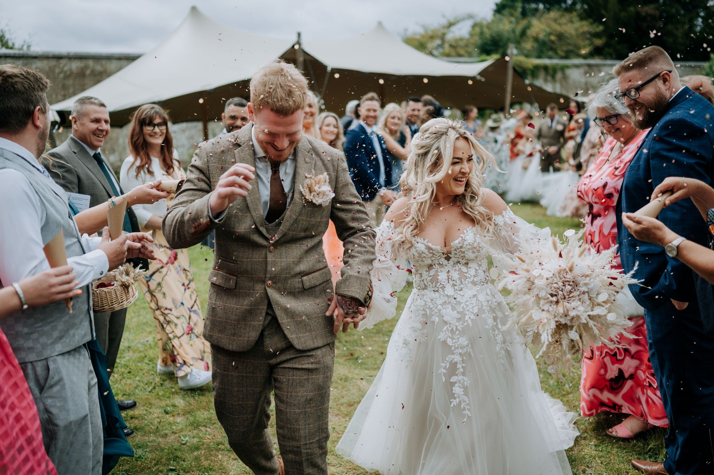 Bride and groom celebrating during outdoor wedding reception at Scrivelsby