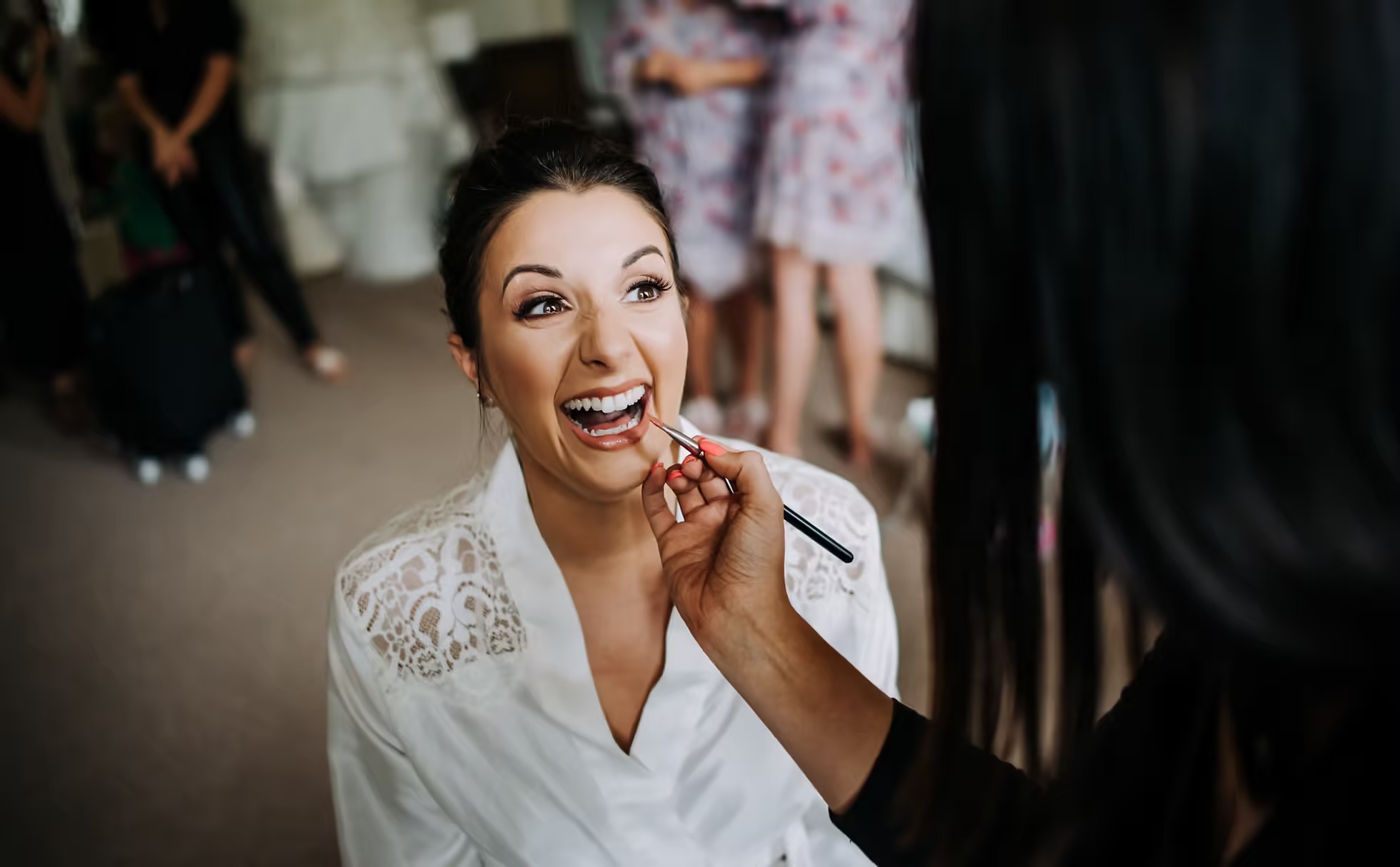 Bride laughing during wedding morning preparations at Rise Hall