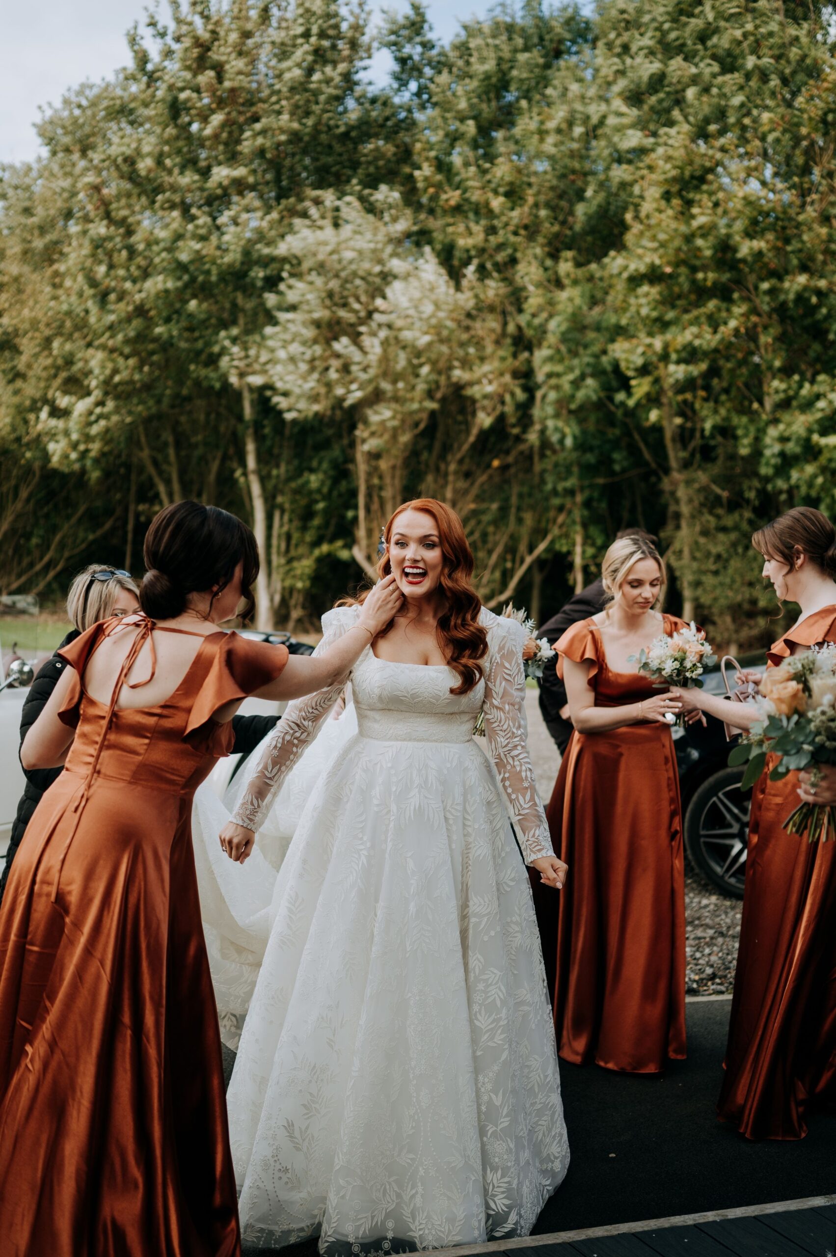 Bride celebrating with bridesmaids at Oaklands wedding venue