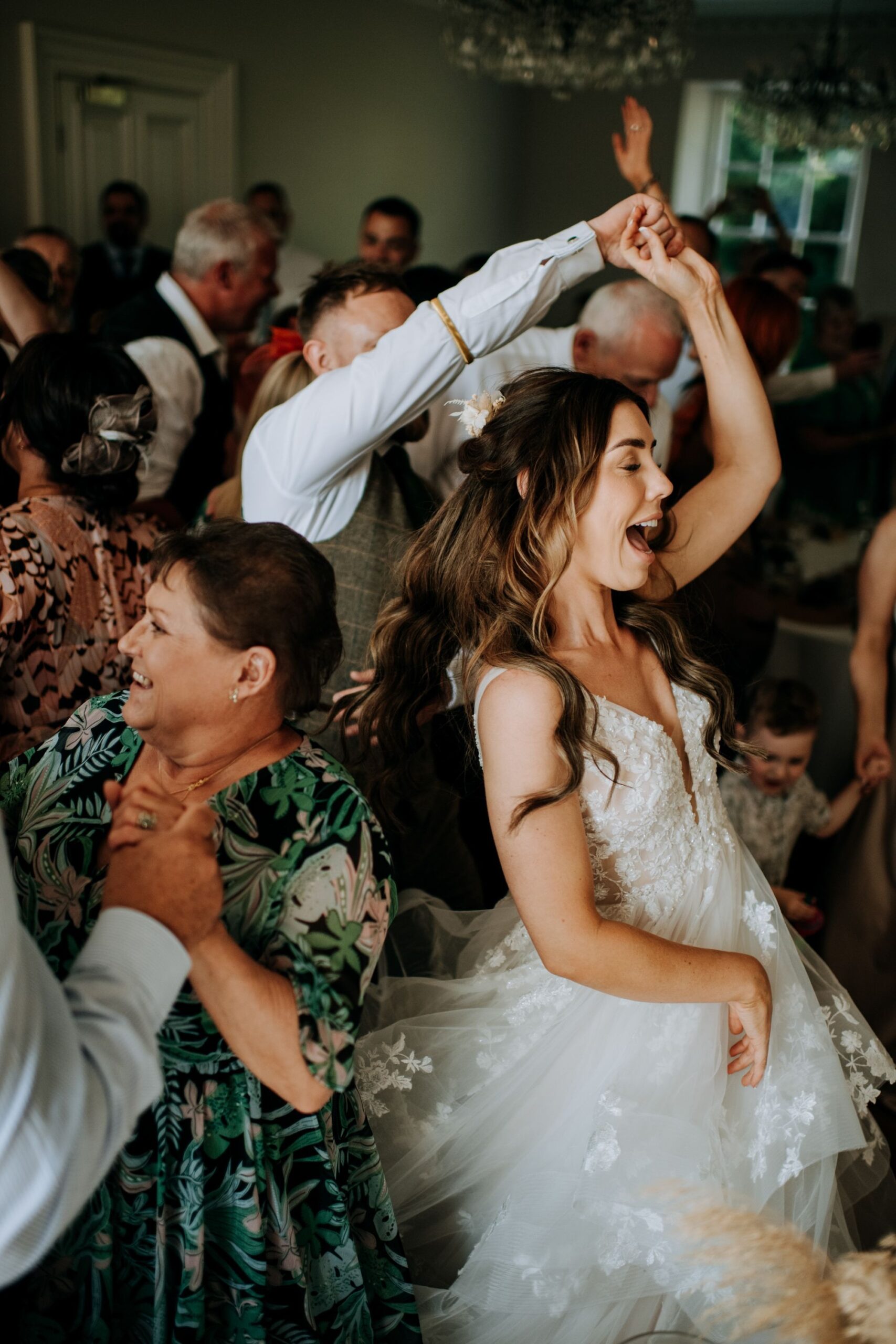 Bride dancing during evening wedding reception at Hirst Priory