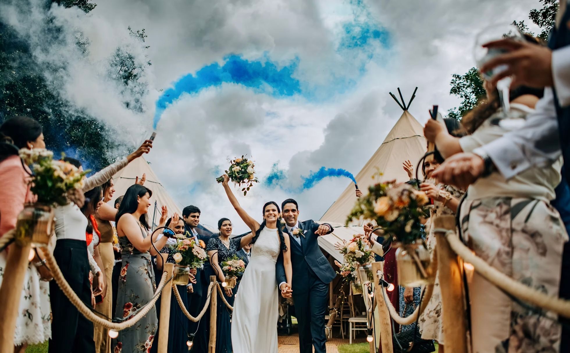 Wedding guests celebrating with smoke bombs at Hirst Priory