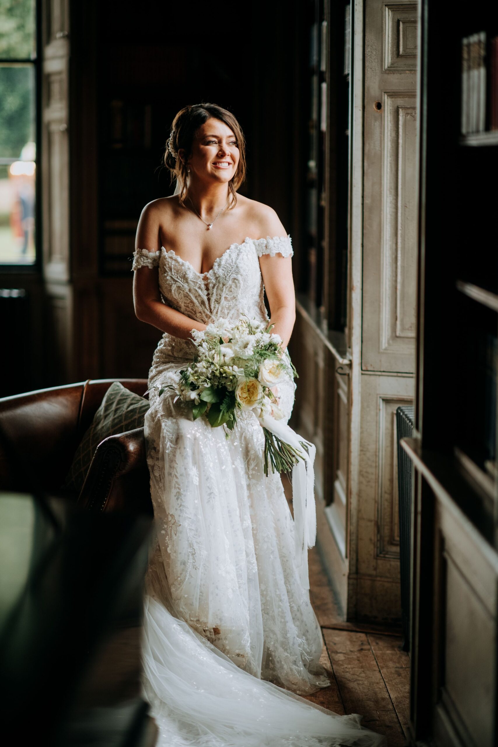 Bride standing by window inside Rise Hall wedding venue