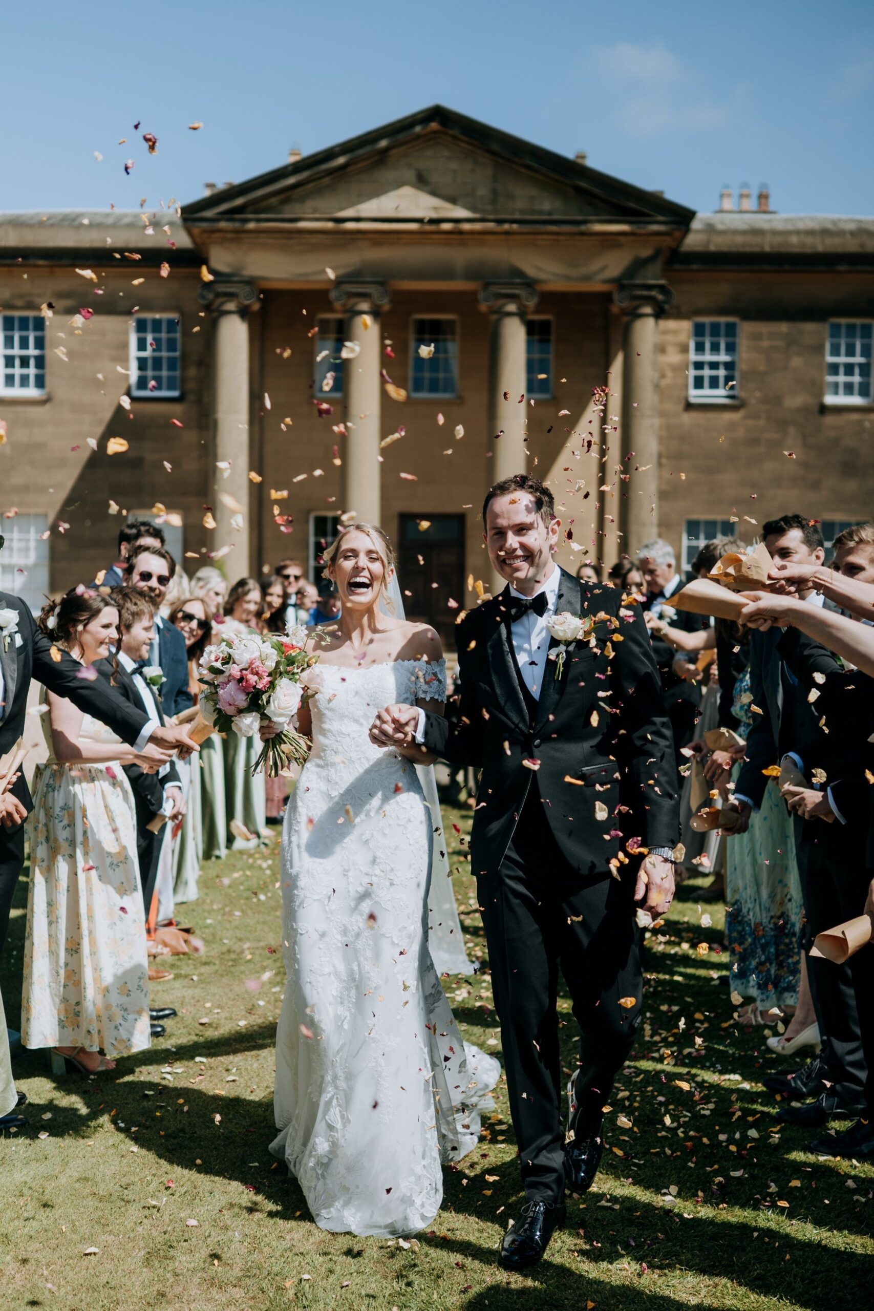 Bride and groom confetti exit at Rise Hall wedding venue