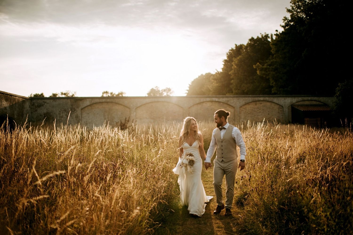Bride and groom portrait in field at sunset in Lincolnshire