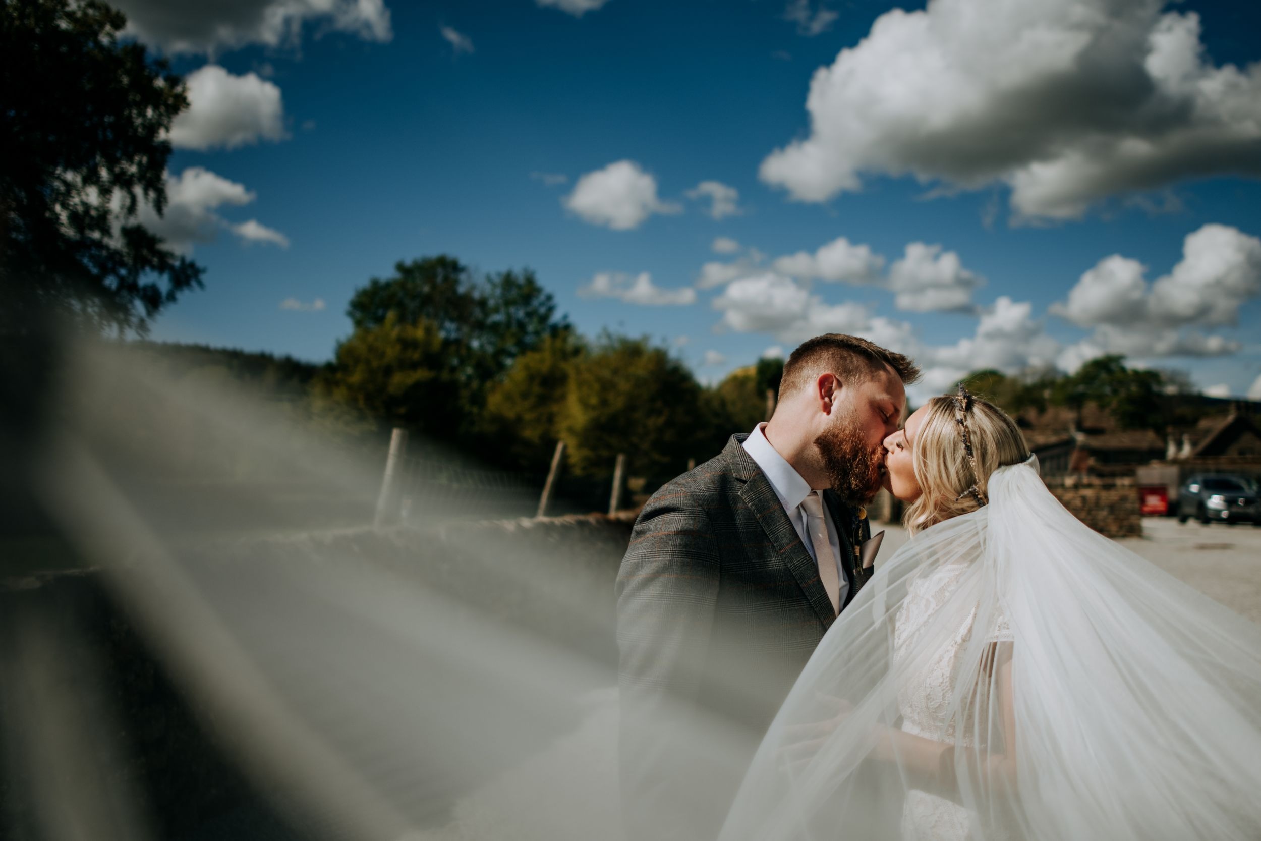 Bride and Groom Kissing at Wedding Photography Tithe Barn