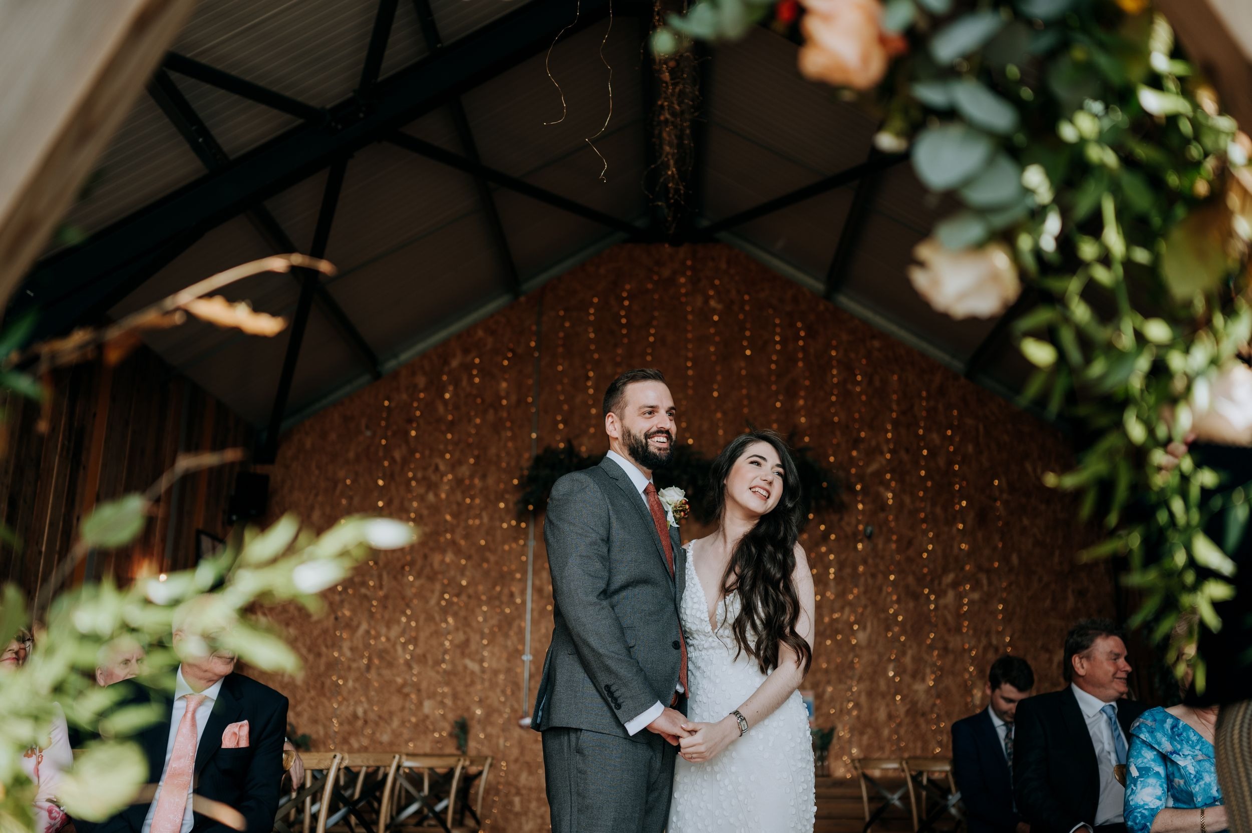 Bride and groom portrait inside Little Wold Vineyard barn venue