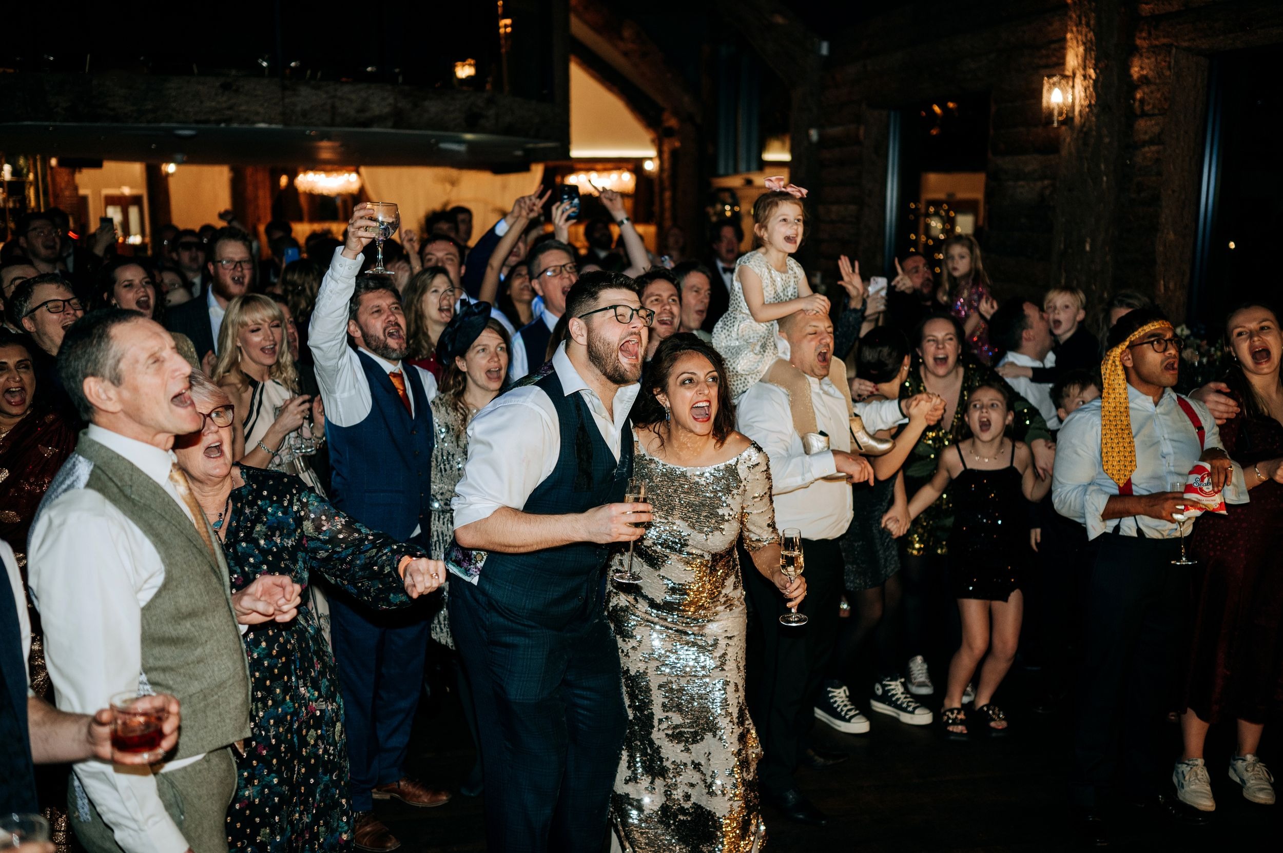 Wedding guests celebrating during evening reception at Oaklands