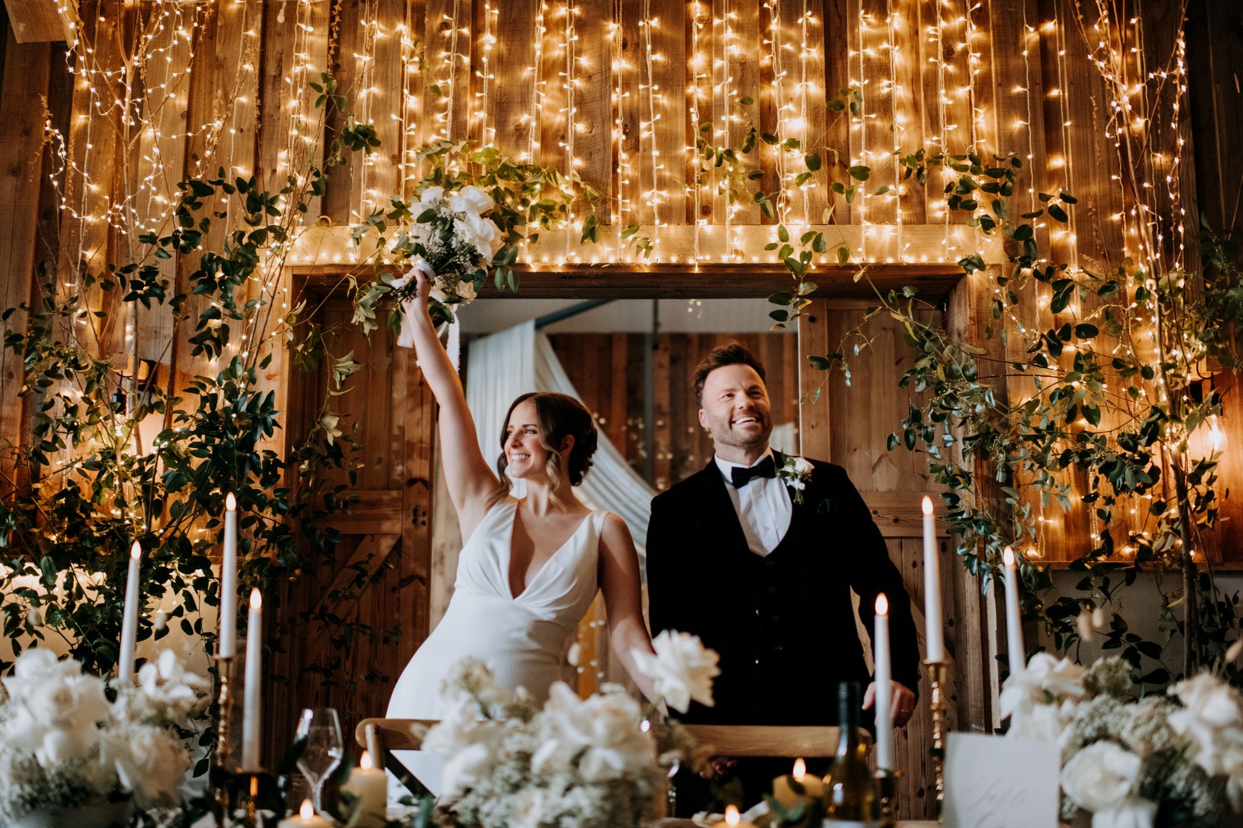 Bride and groom beneath fairy lights at Little Wold Vineyard wedding