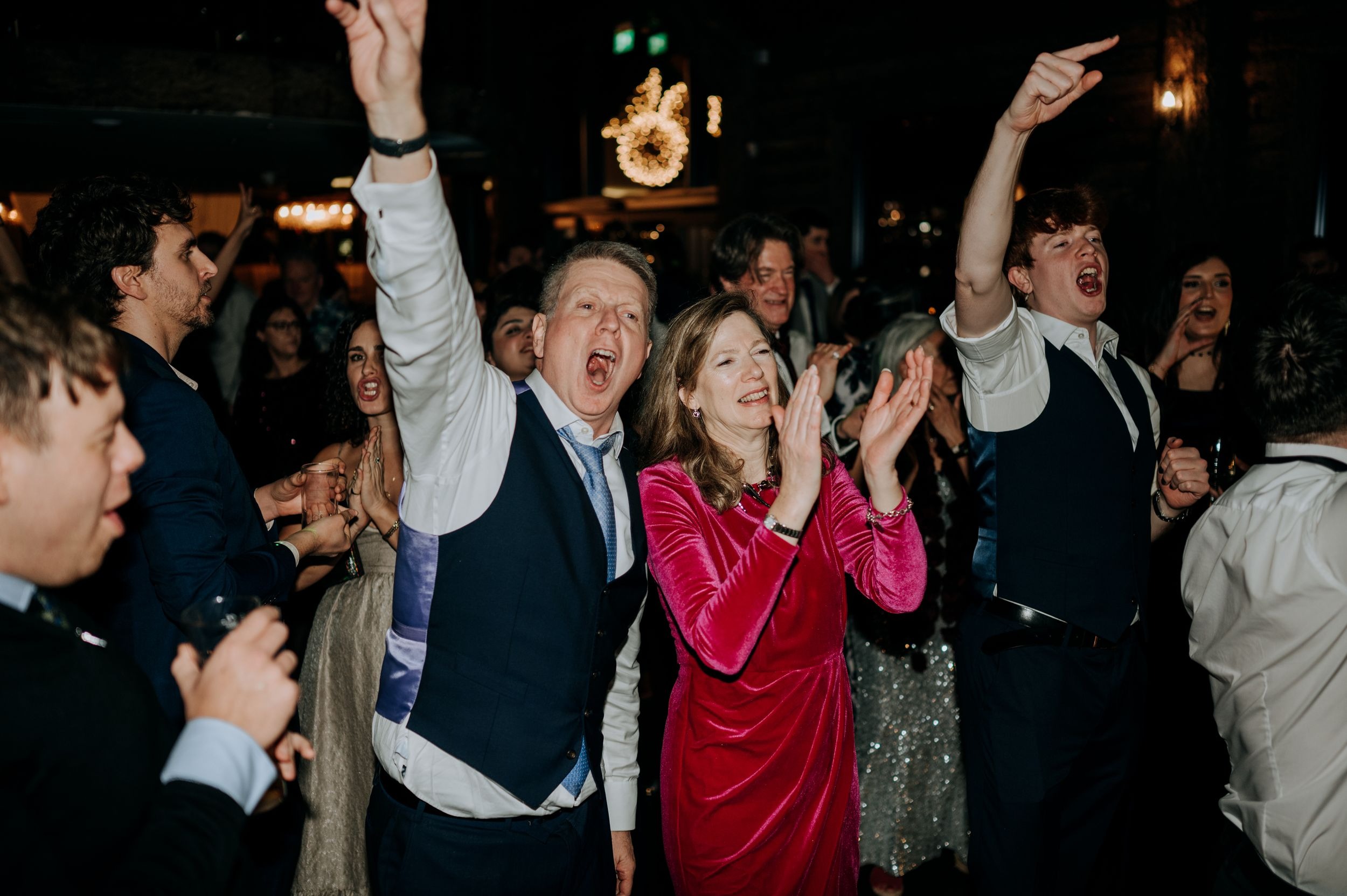 Guests dancing and cheering at Oaklands wedding party