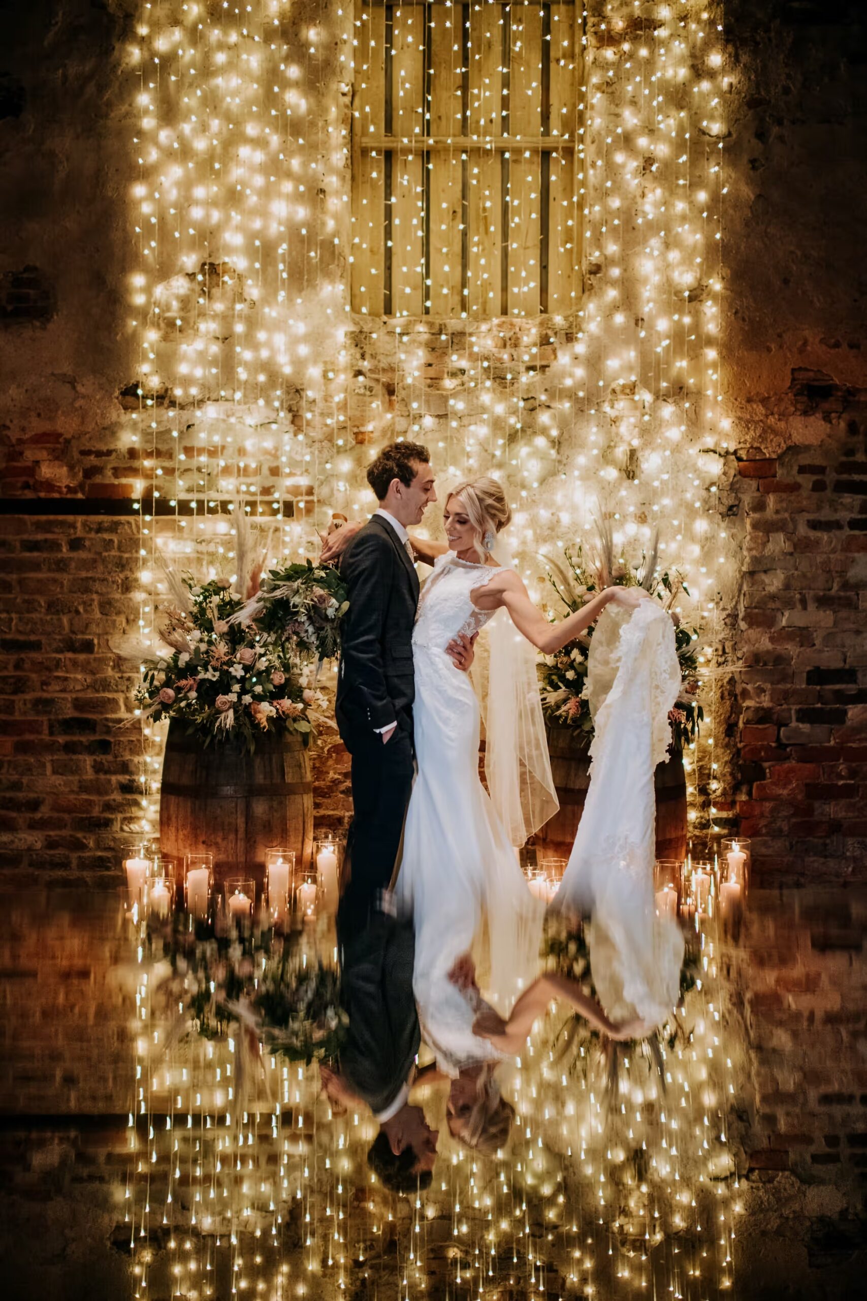 Bride and groom first dance beneath fairy lights at The Normans