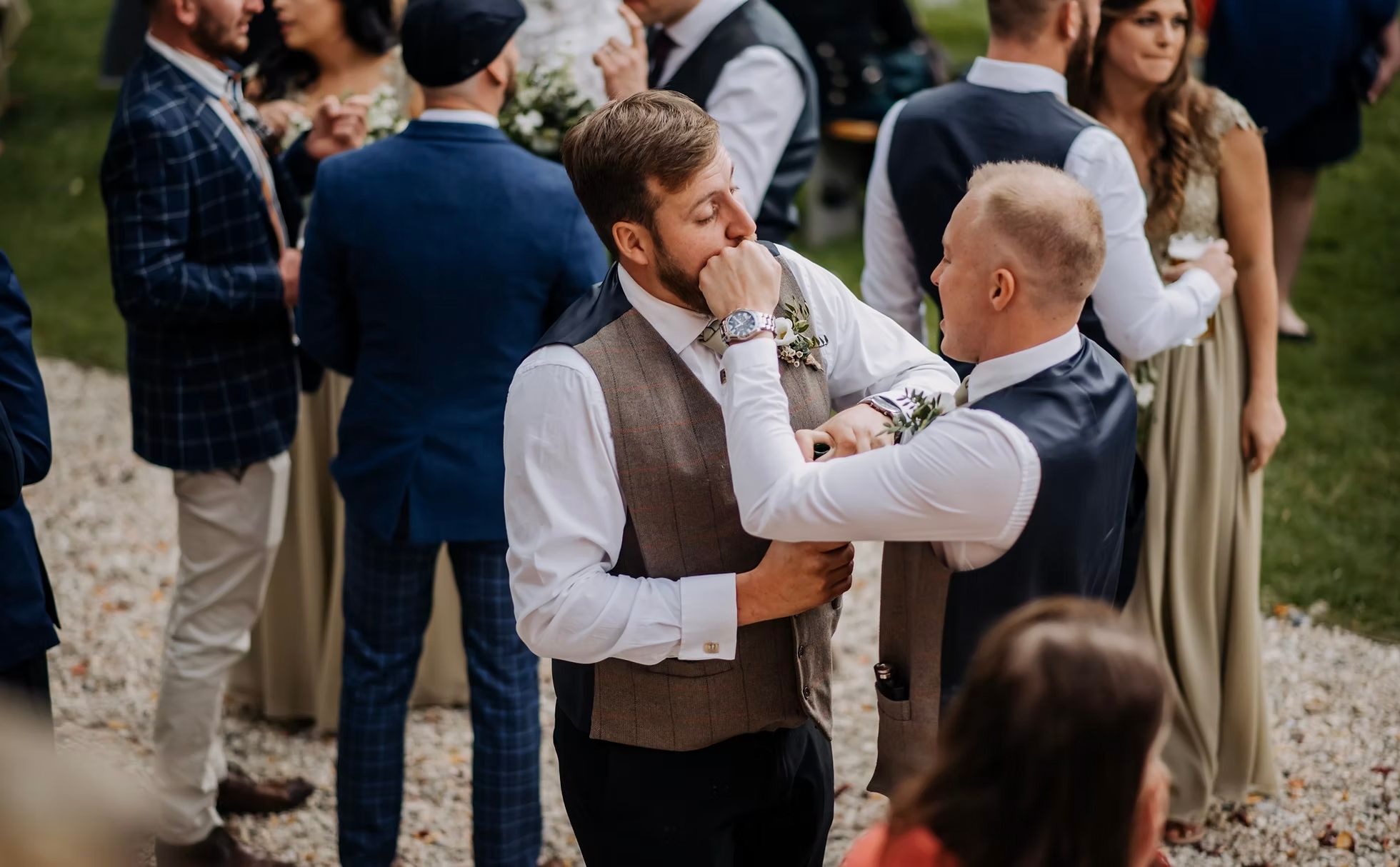 Wedding guests during outdoor drinks reception at Hirst Priory
