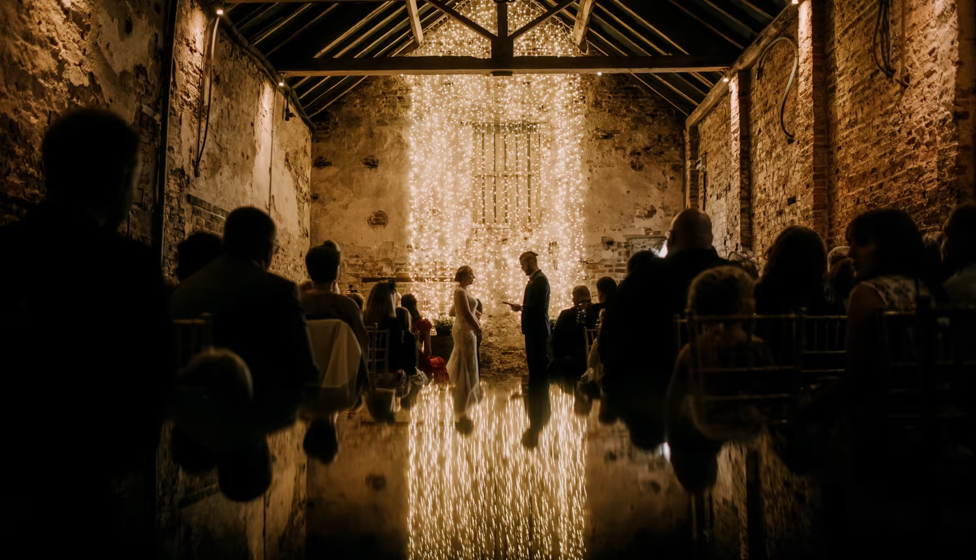Wedding ceremony setup inside The Normans wedding barn