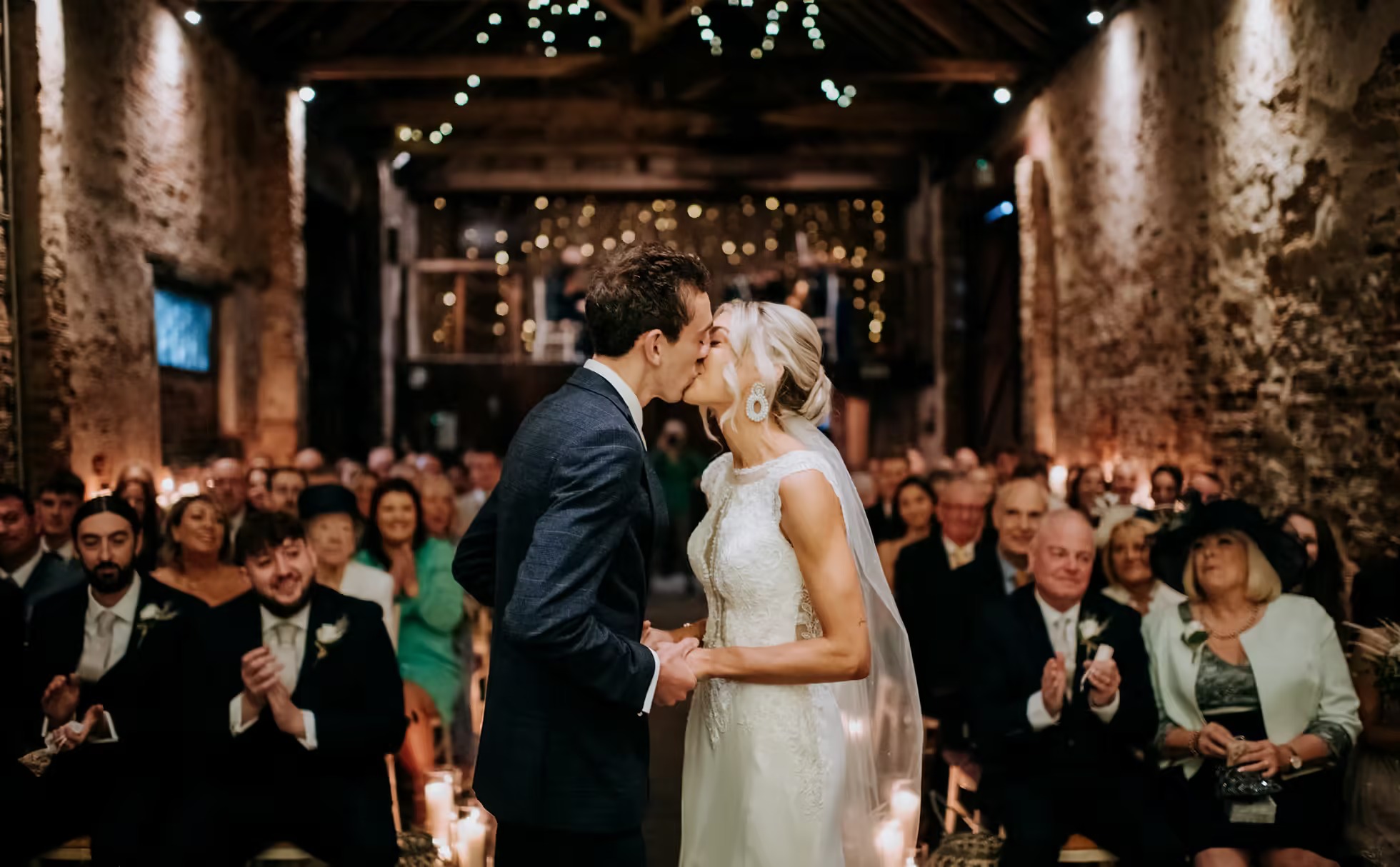 Bride and groom kissing during ceremony at The Normans