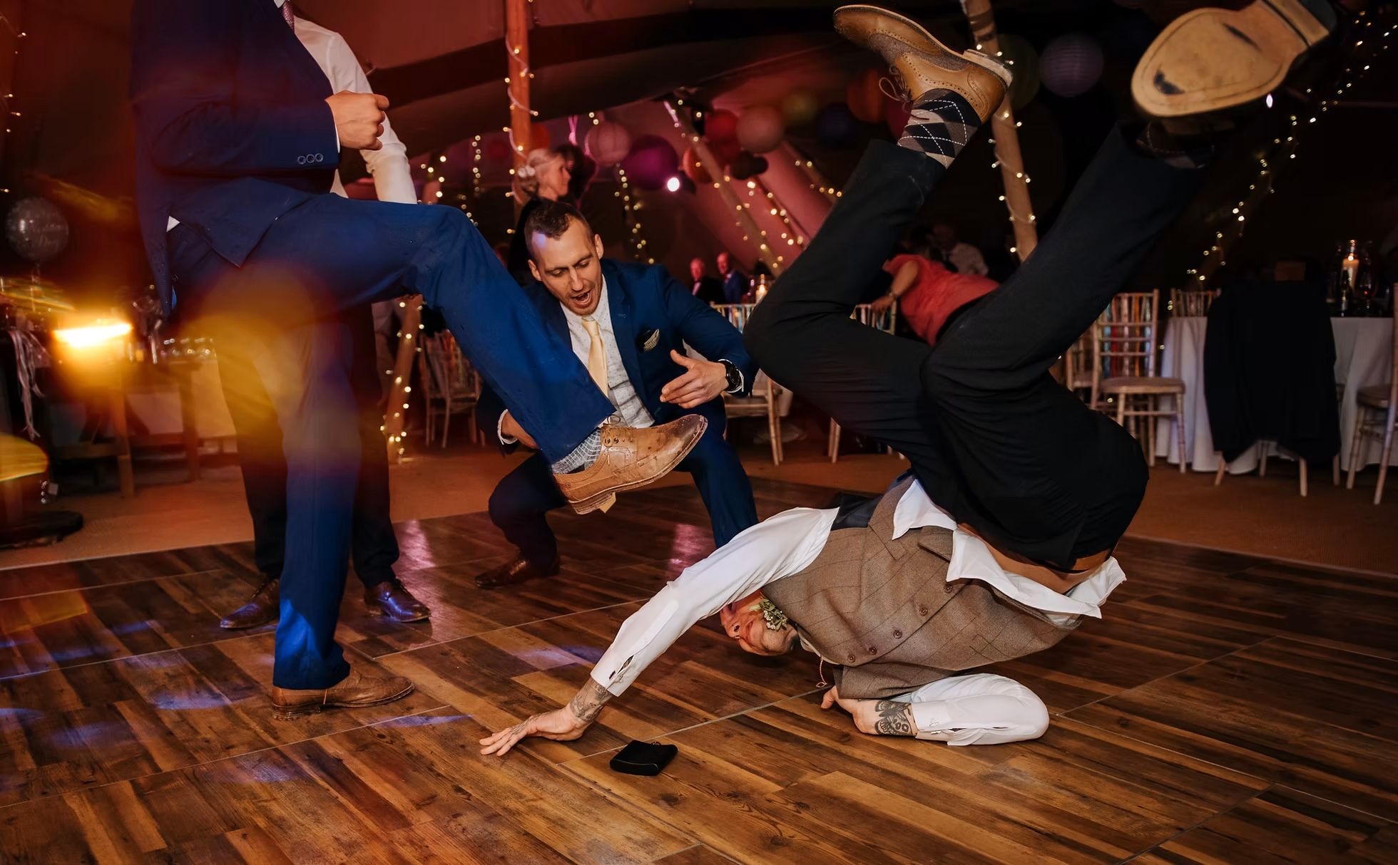 Guests breakdancing during evening wedding reception at Hirst Priory