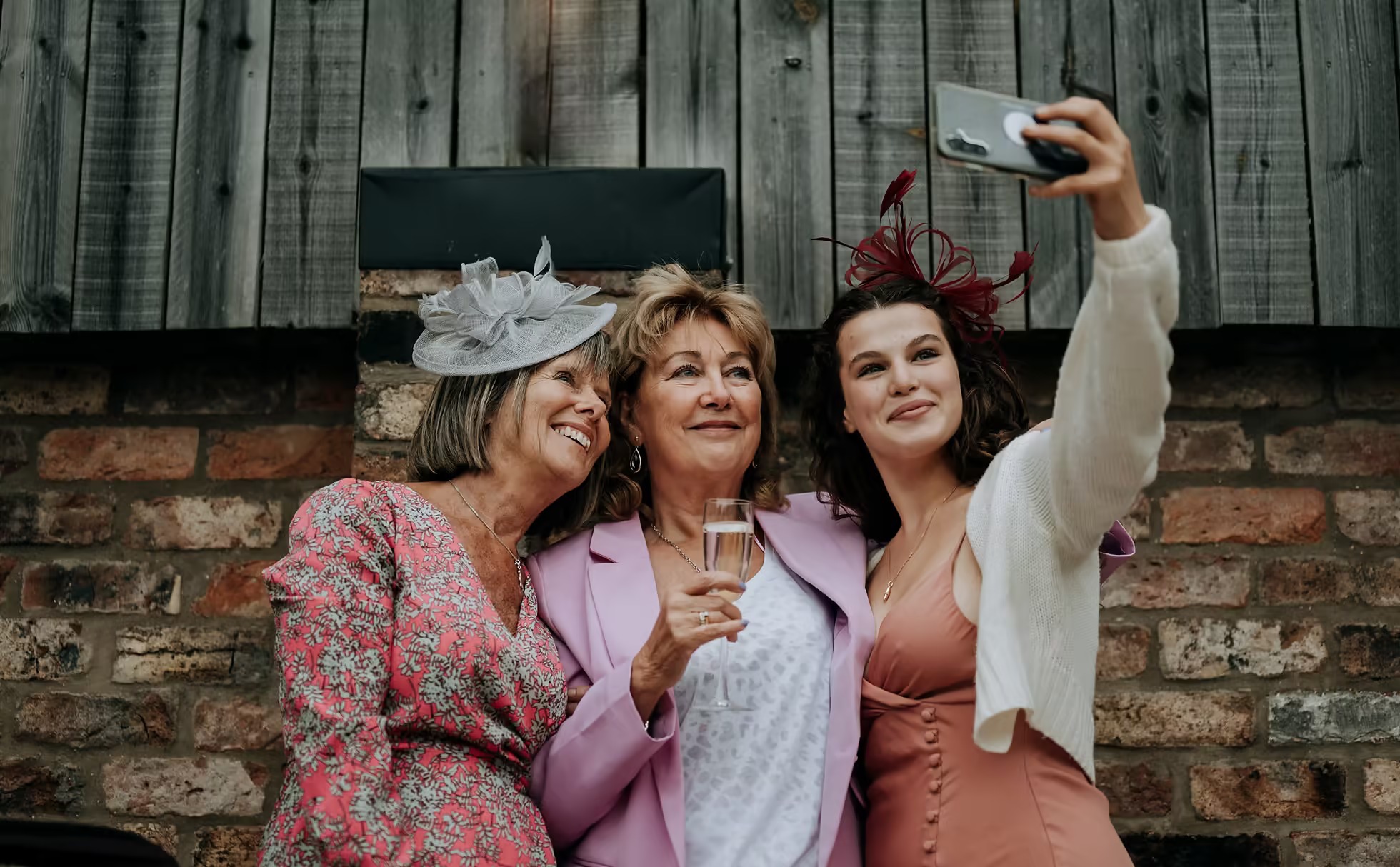 Bridesmaids taking selfie during wedding morning at The Normans