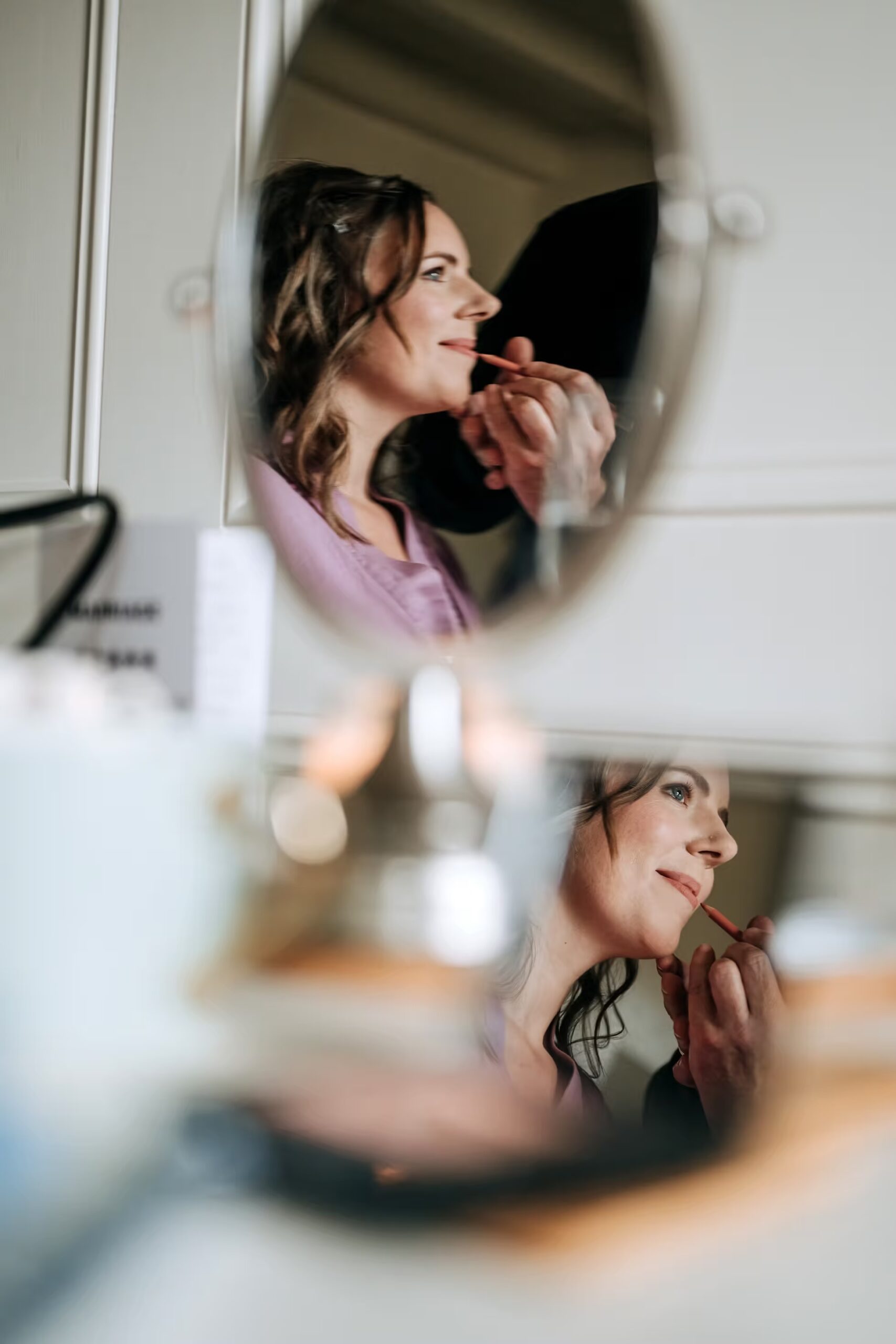 Bride reflection portrait during wedding preparations at The Normans