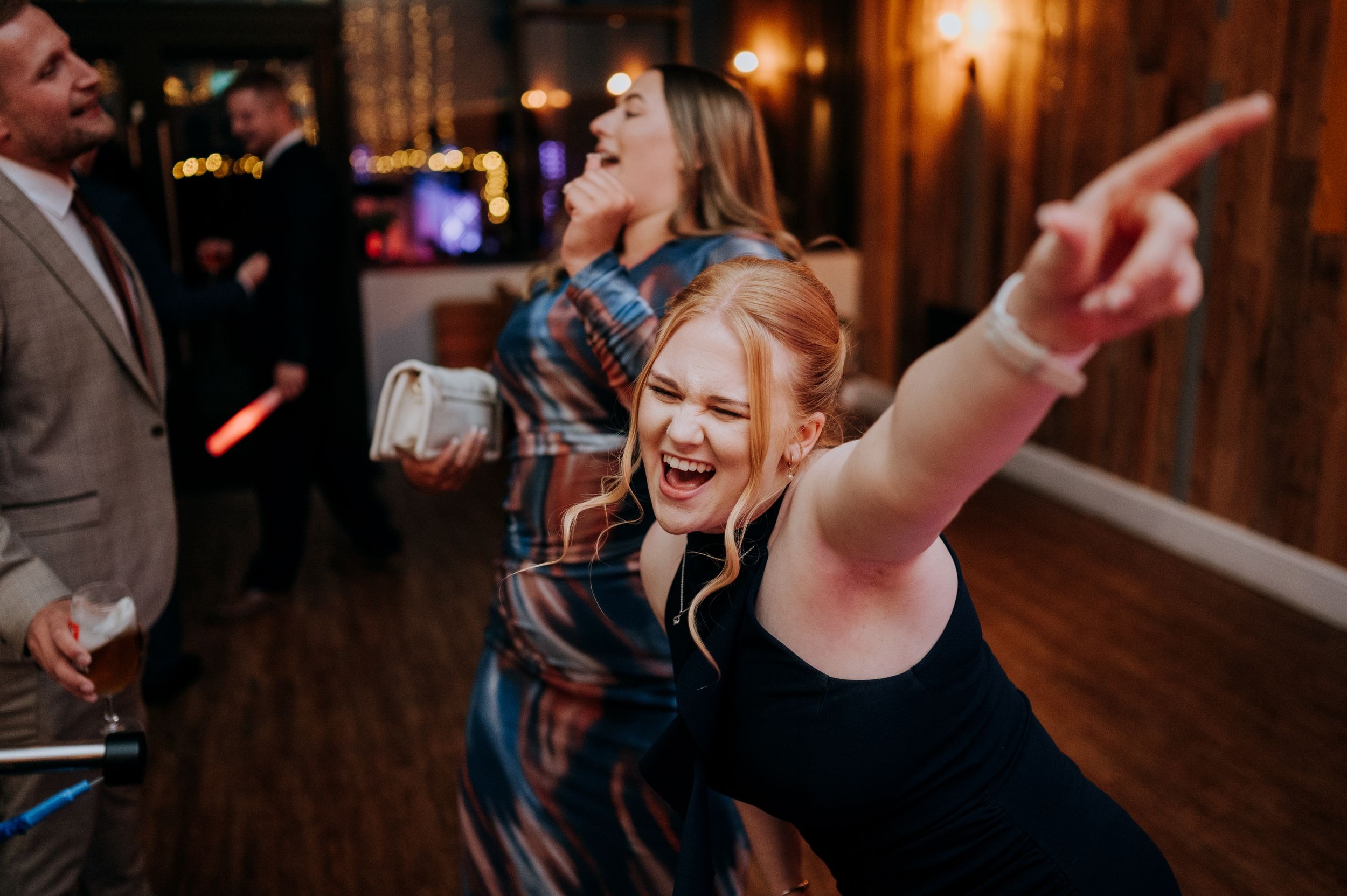 Guest dancing during evening wedding reception at Little Wold Vineyard