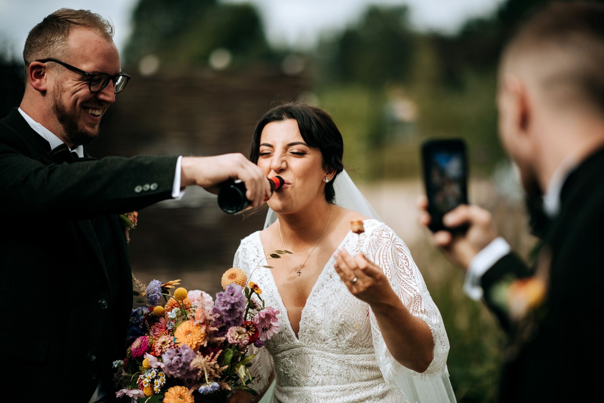 Bride laughing during wedding speeches at Riverlands