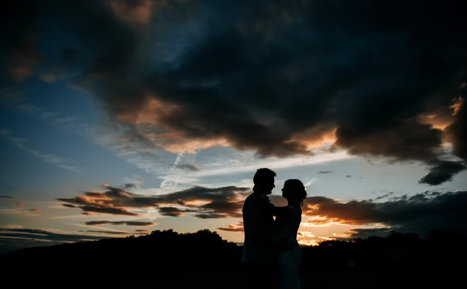 Dramatic sunset wedding portrait at Little Wold Vineyard