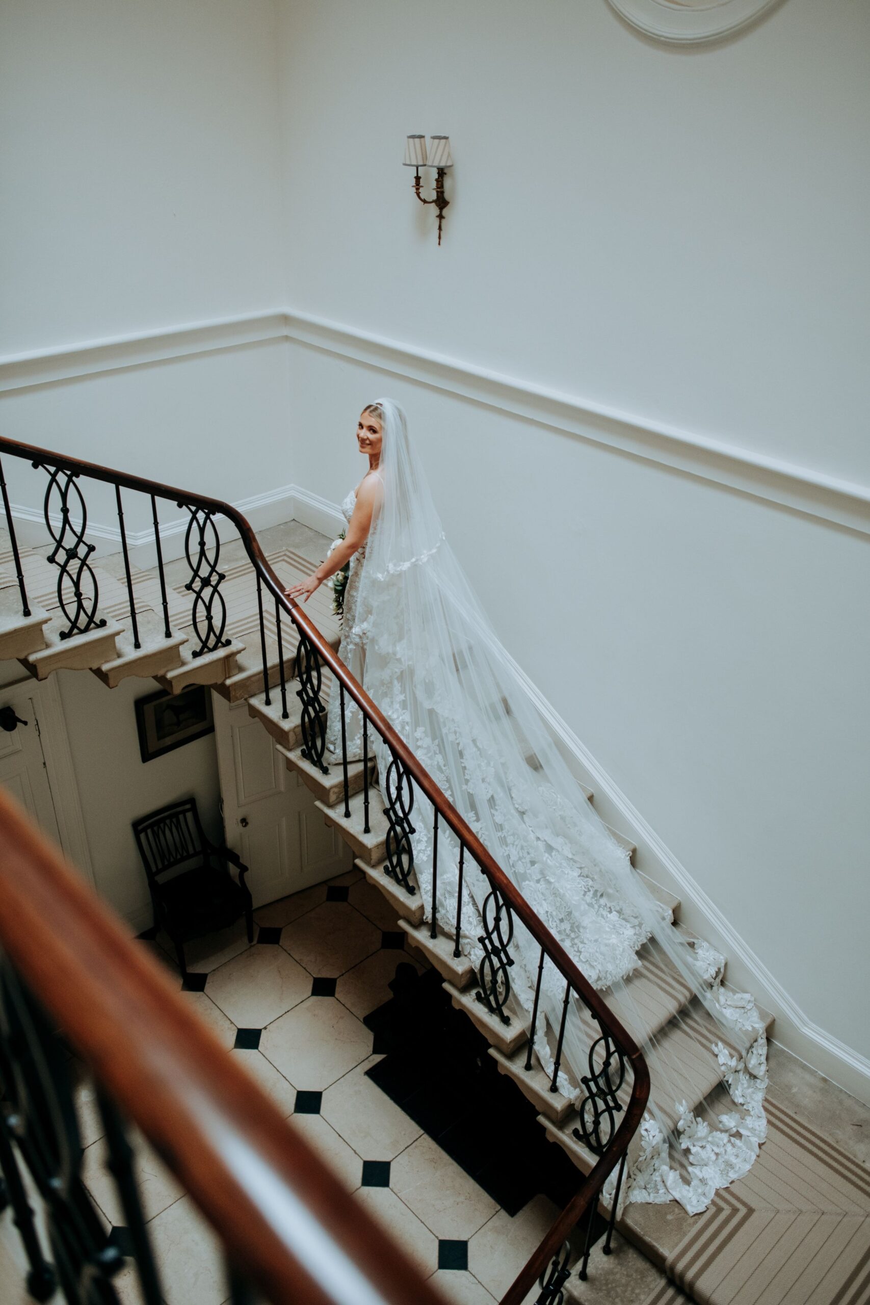 Bride descending staircase at Wootton Hall wedding venue