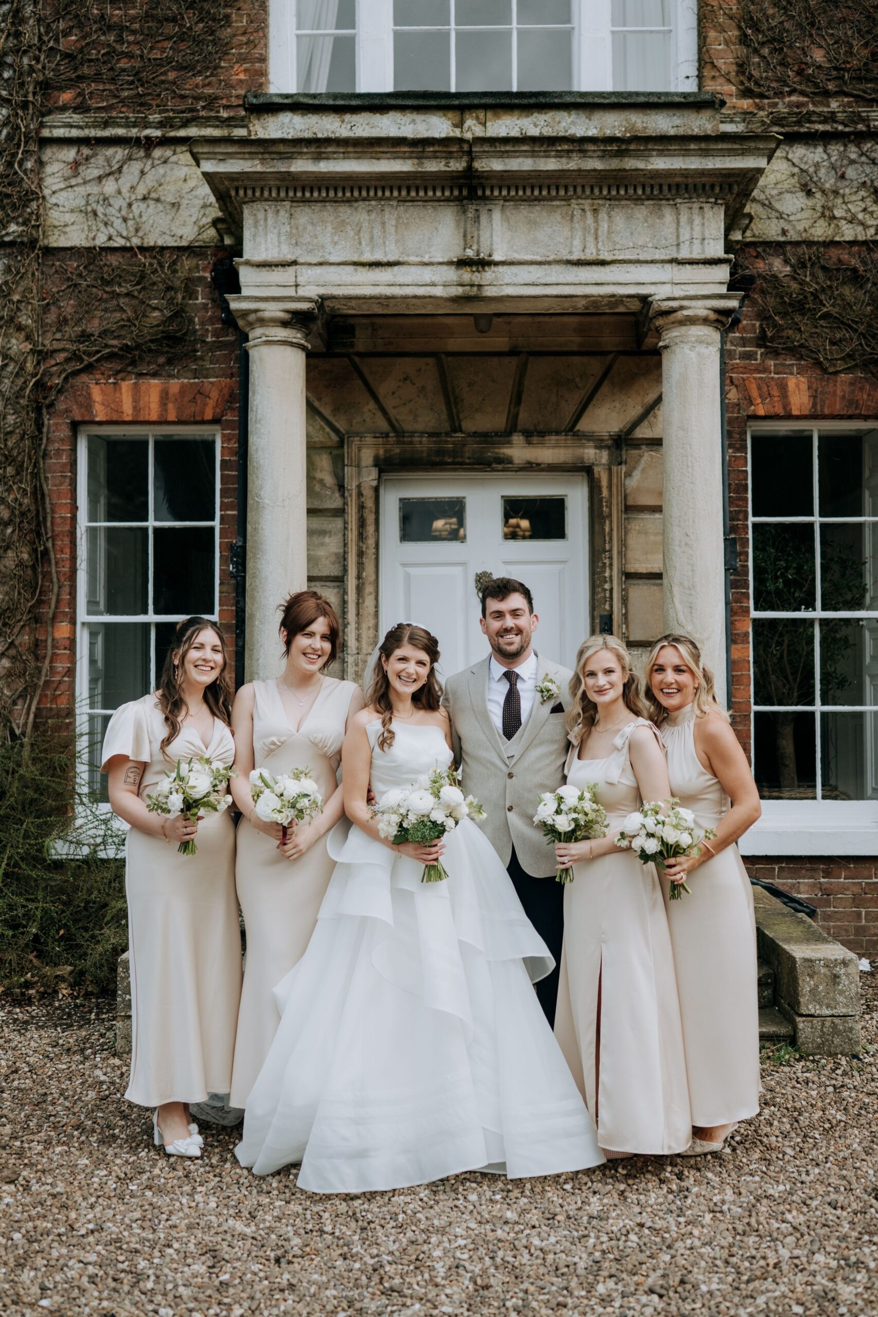 Bride and Groom with Bridesmaids portrait outside Wootton Hall wedding venue