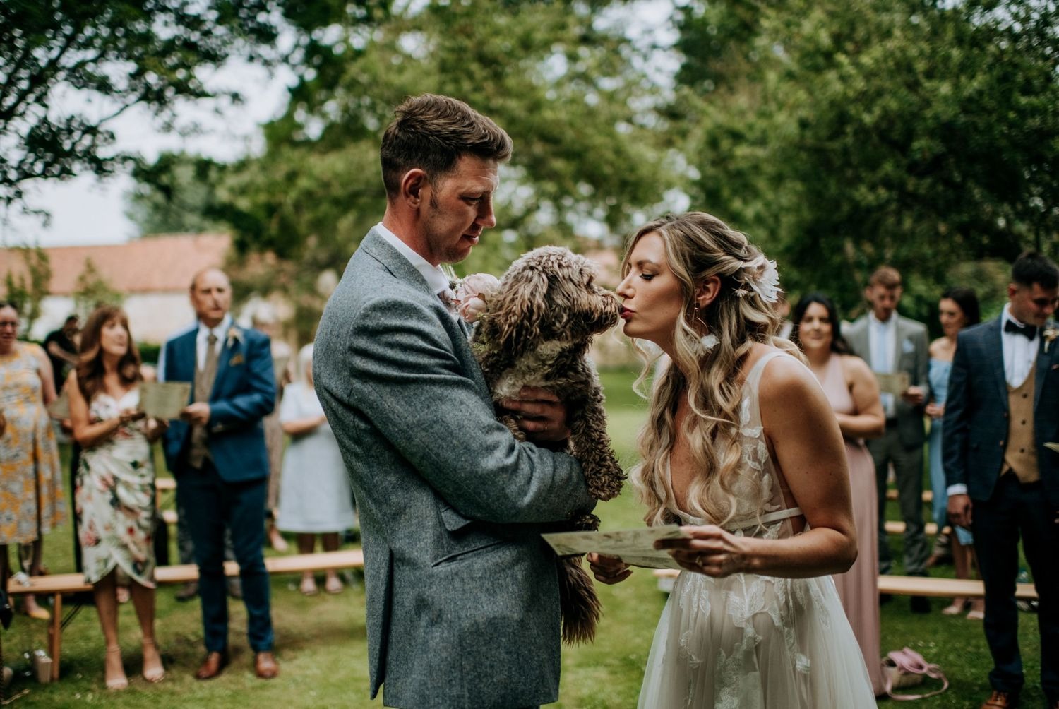 Bride and groom embracing during outdoor ceremony in Lincolnshire