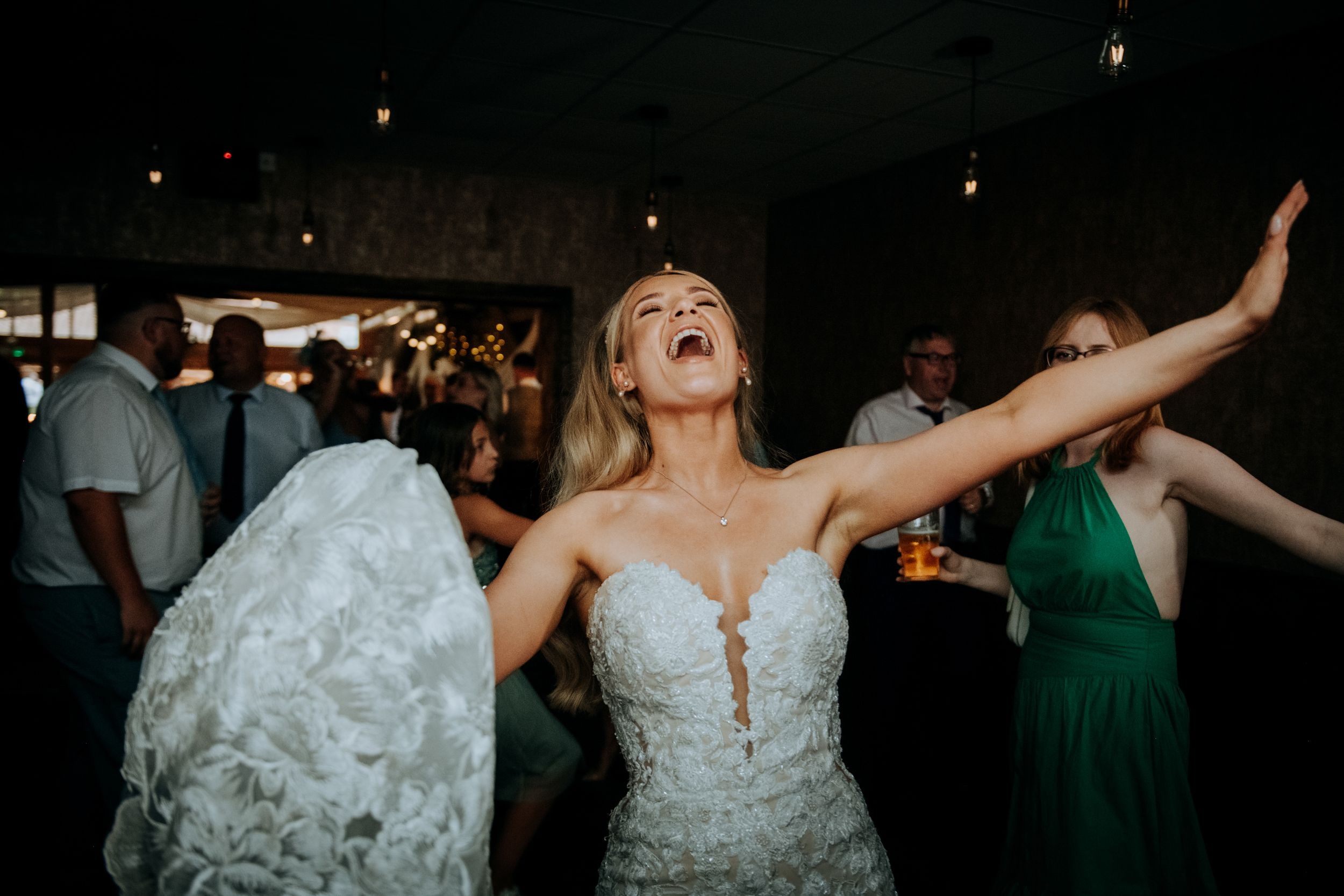 Bride celebrating on dancefloor at Wootton Hall wedding reception