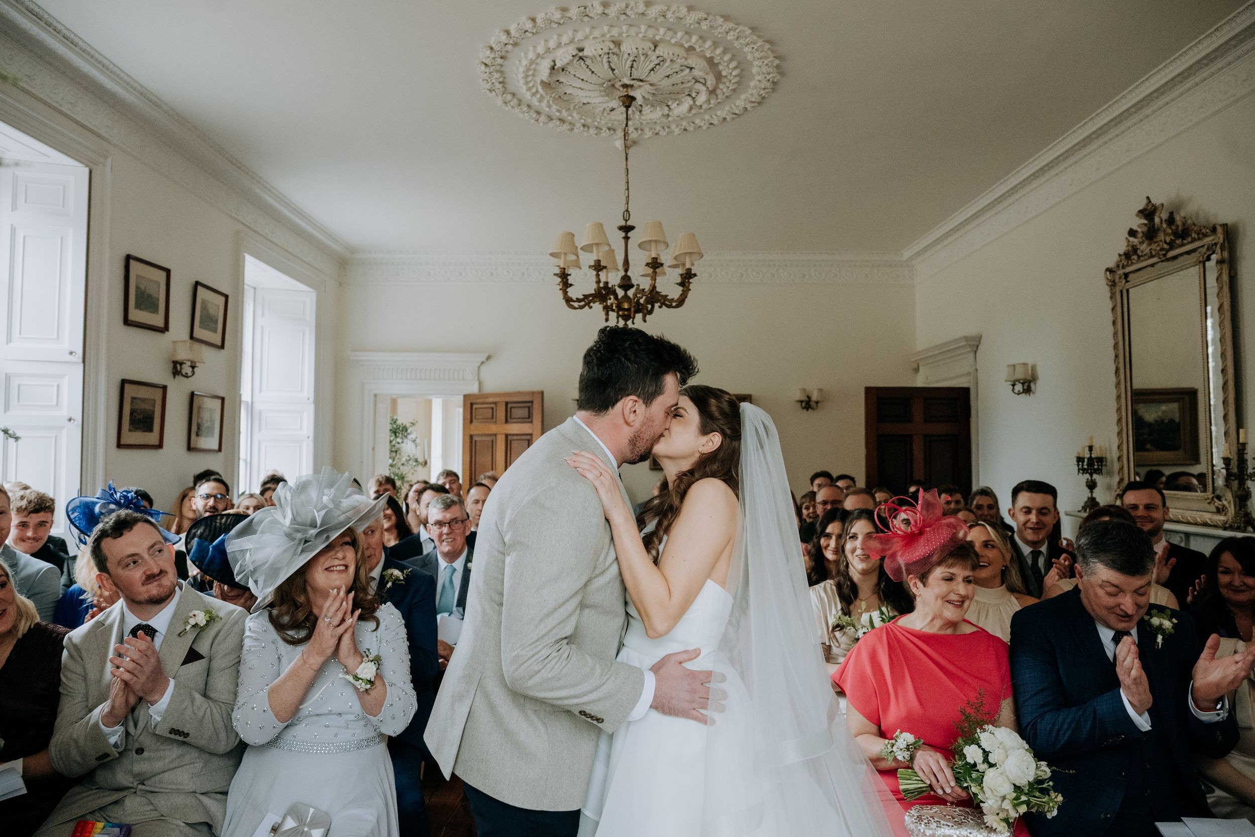 Bride and groom kissing during wedding ceremony at Wootton Hall