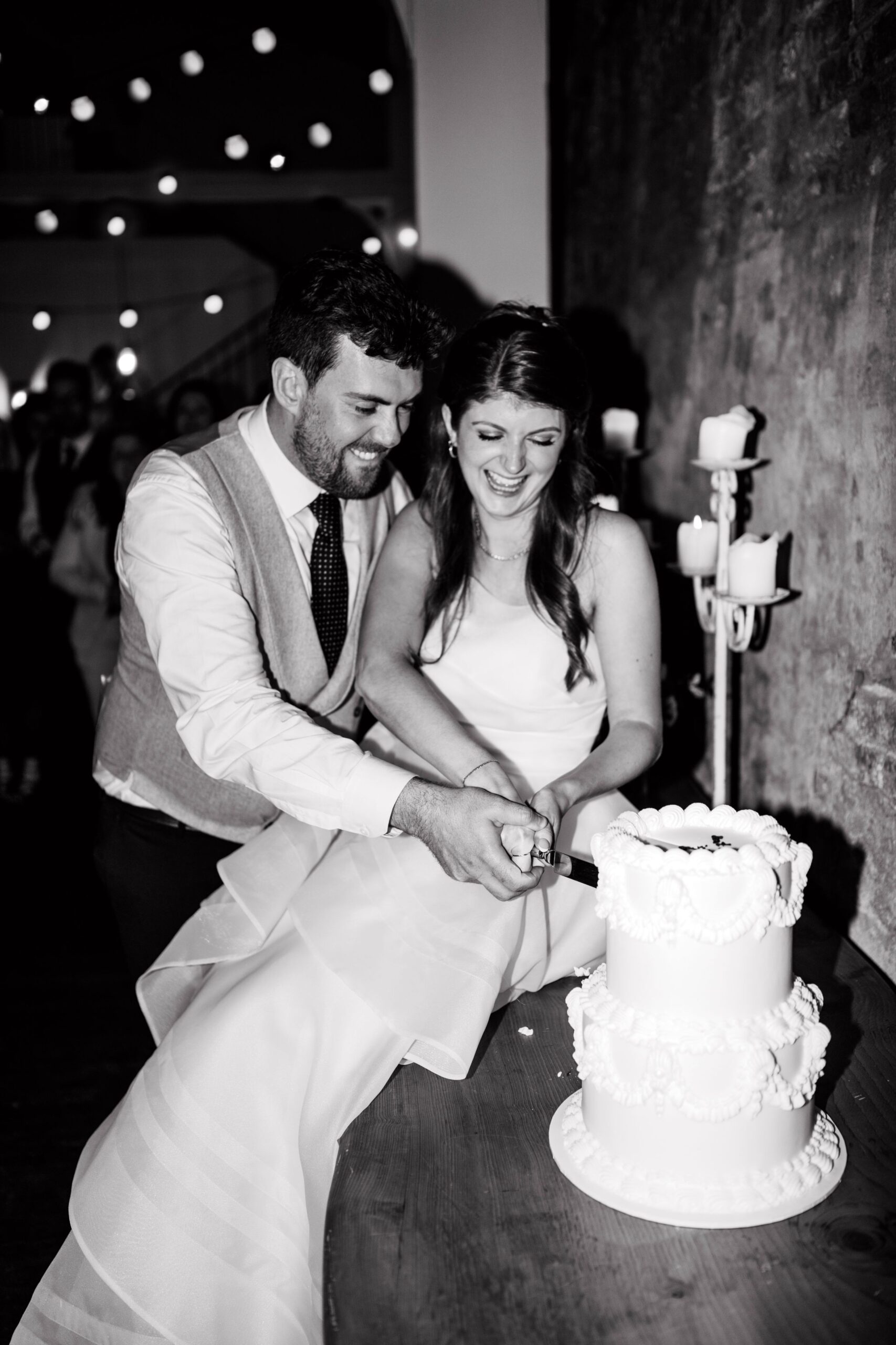 Black and white cake cutting photograph at Wootton Hall wedding