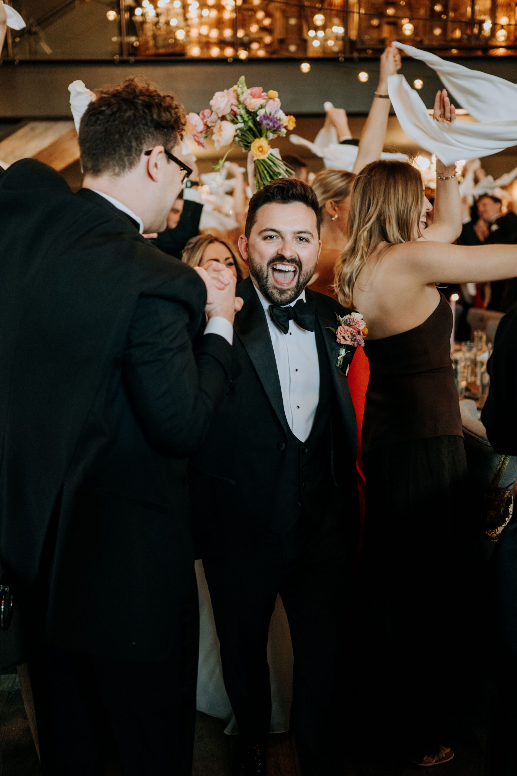 Groom celebrating with guests at Wharfedale Grange