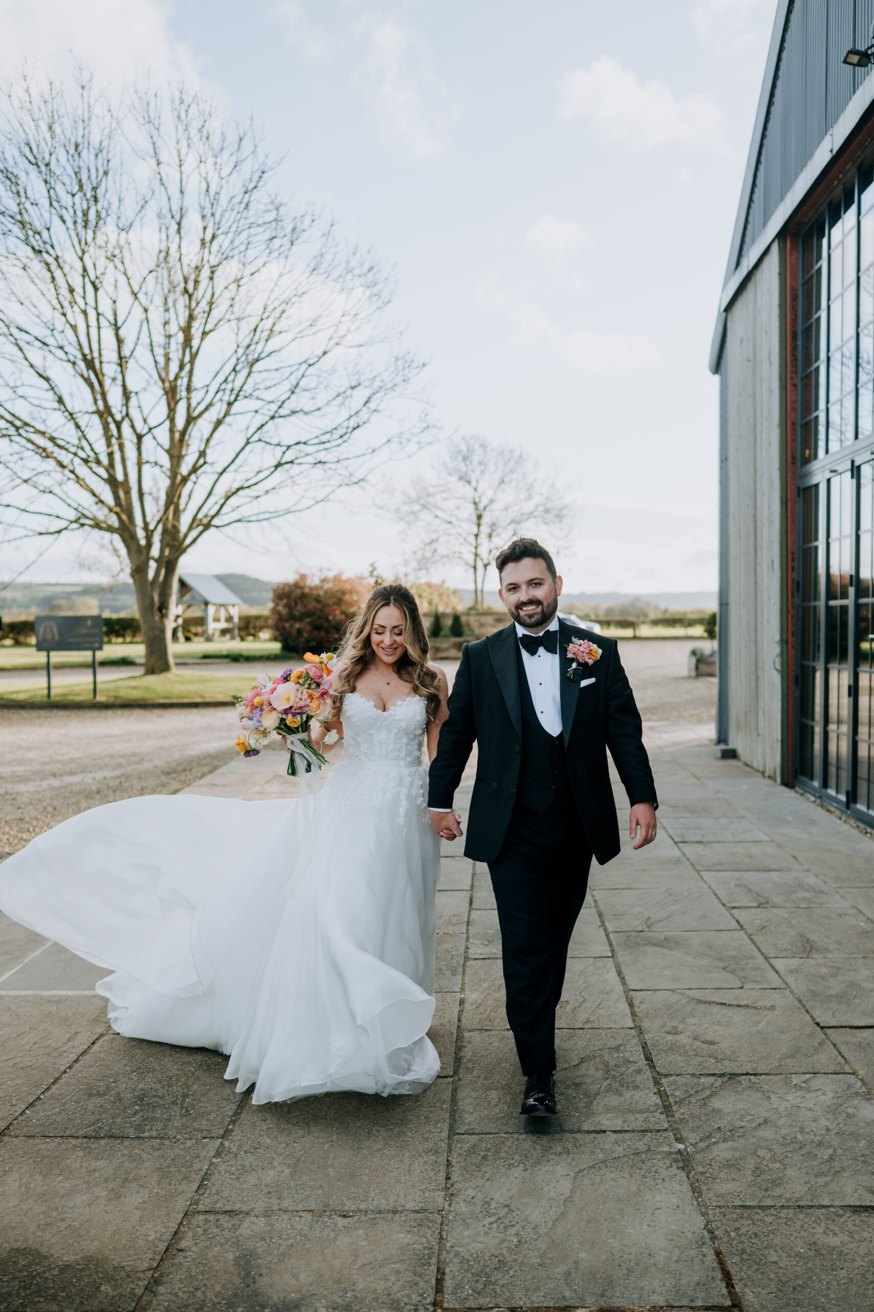 Bride and groom walking together outside Wharfedale Grange