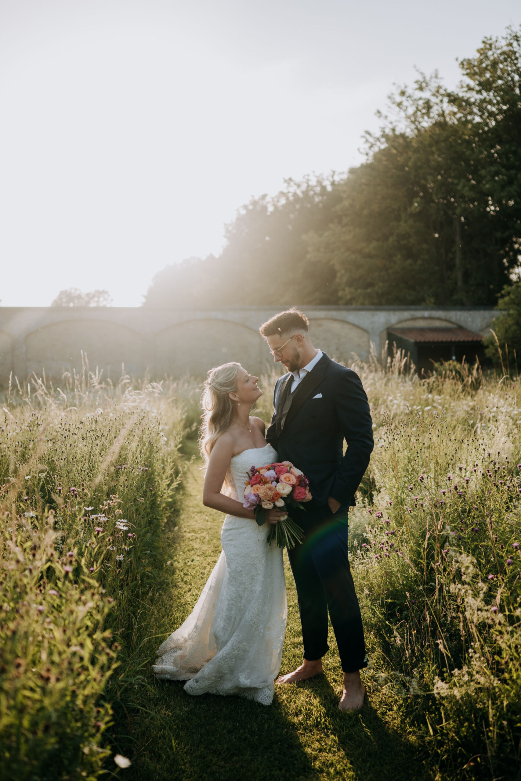 Scrivelsby Walled Garden Wedding - Bride & Groom In Wild Flowers Sunset Picture
