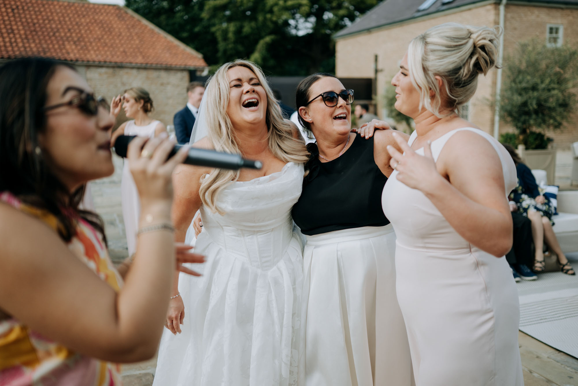 Bride Celebrating with Friends after Hotham Hall Estate Wedding