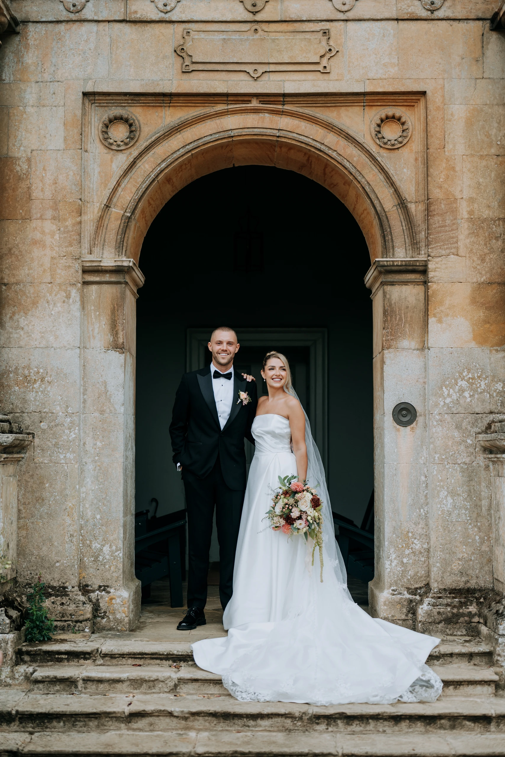 Tiffany and Dan in the stone archway at Doddington Hall