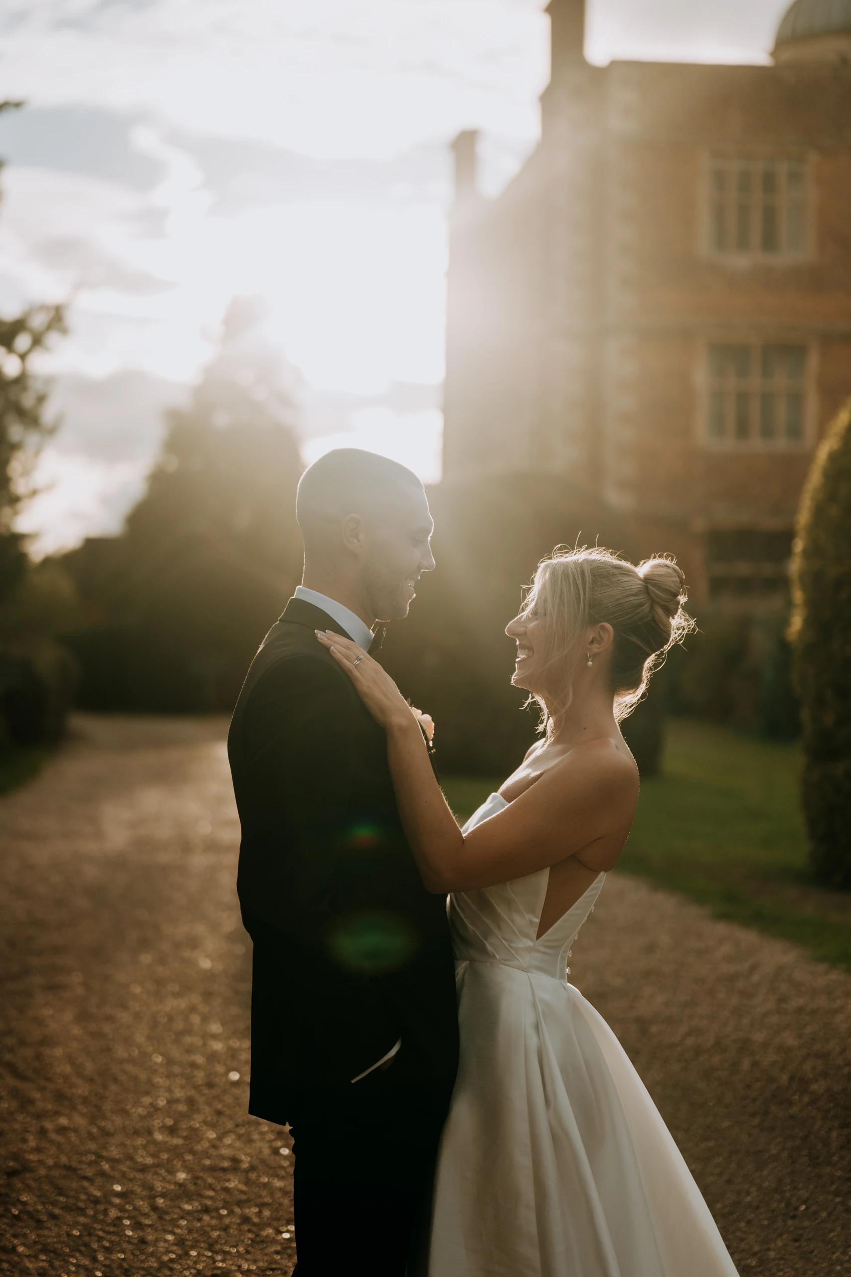 Tiffany and Dan in golden hour light in front of Doddington Hall